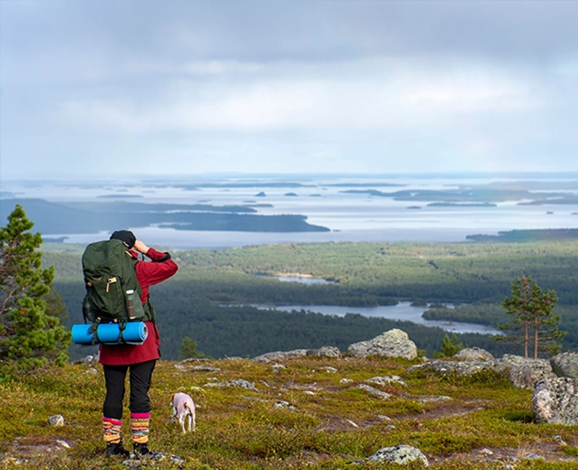 person riding on skis during winter surrounded by mountains