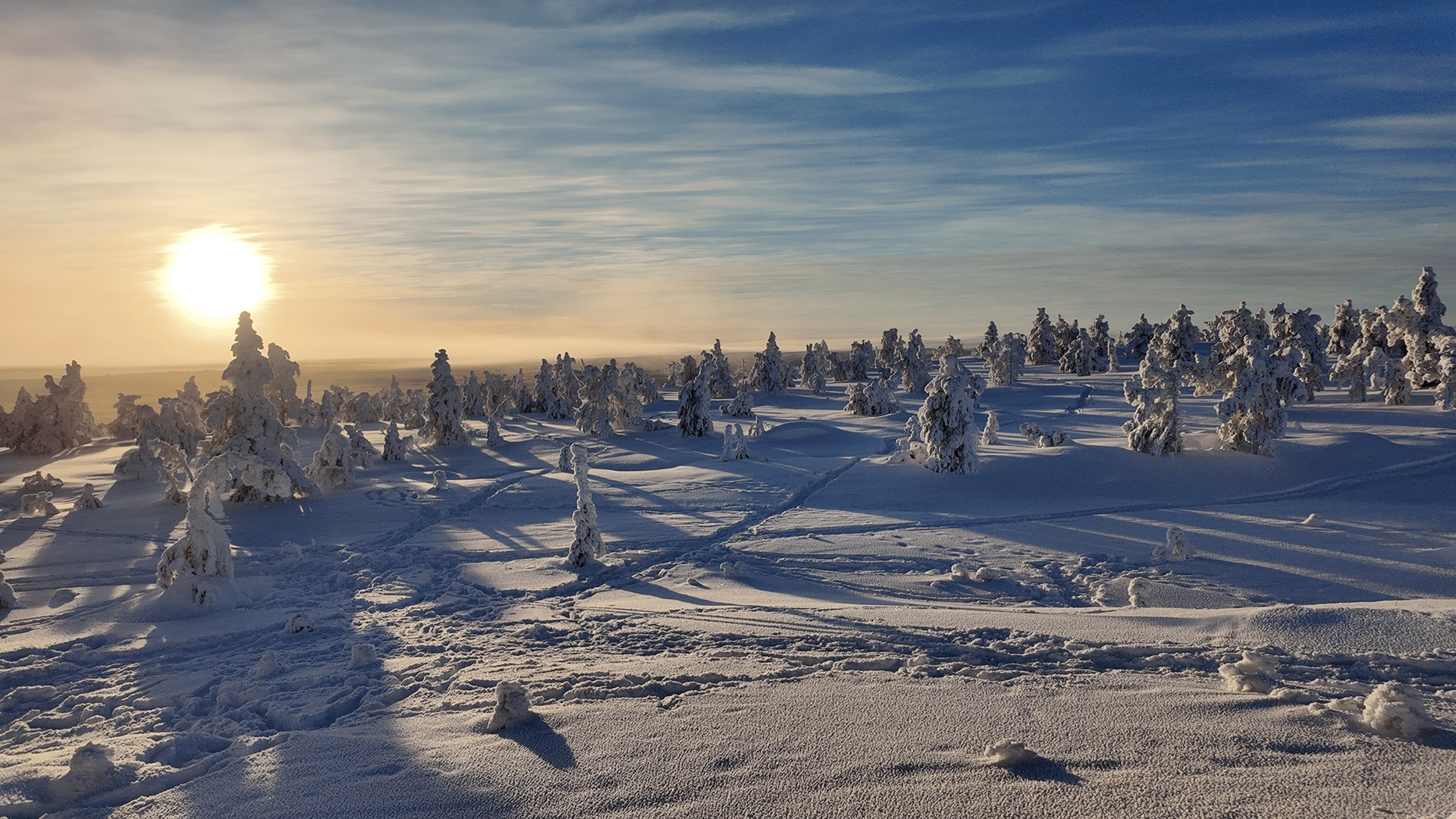 person riding on skis during winter surrounded by mountains