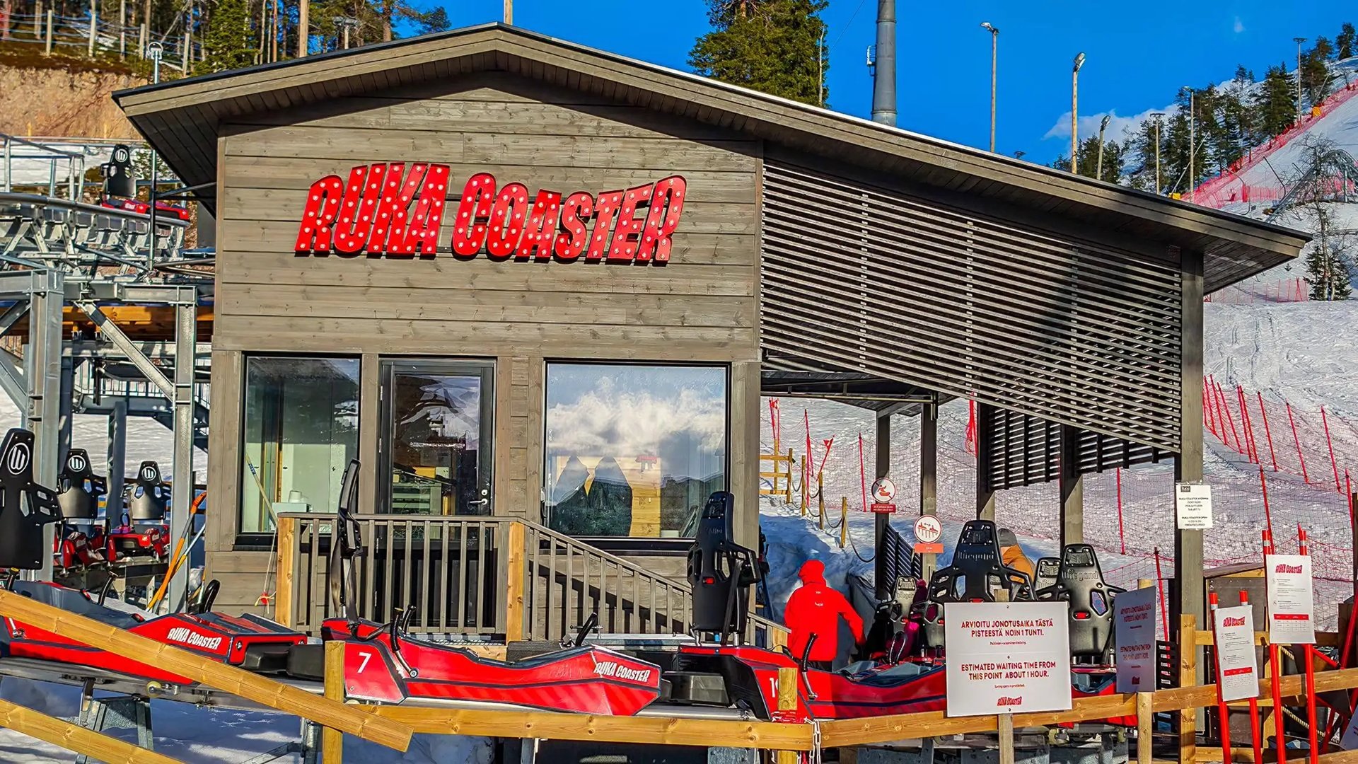 person riding on skis during winter surrounded by mountains