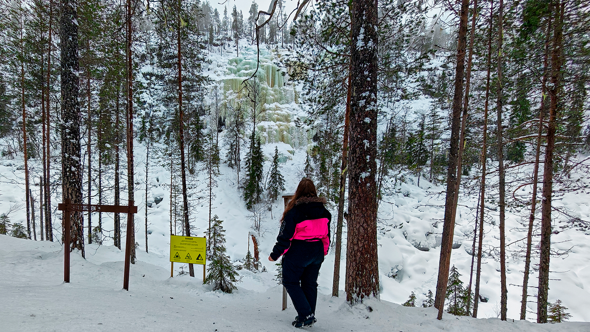 person riding on skis during winter surrounded by mountains
