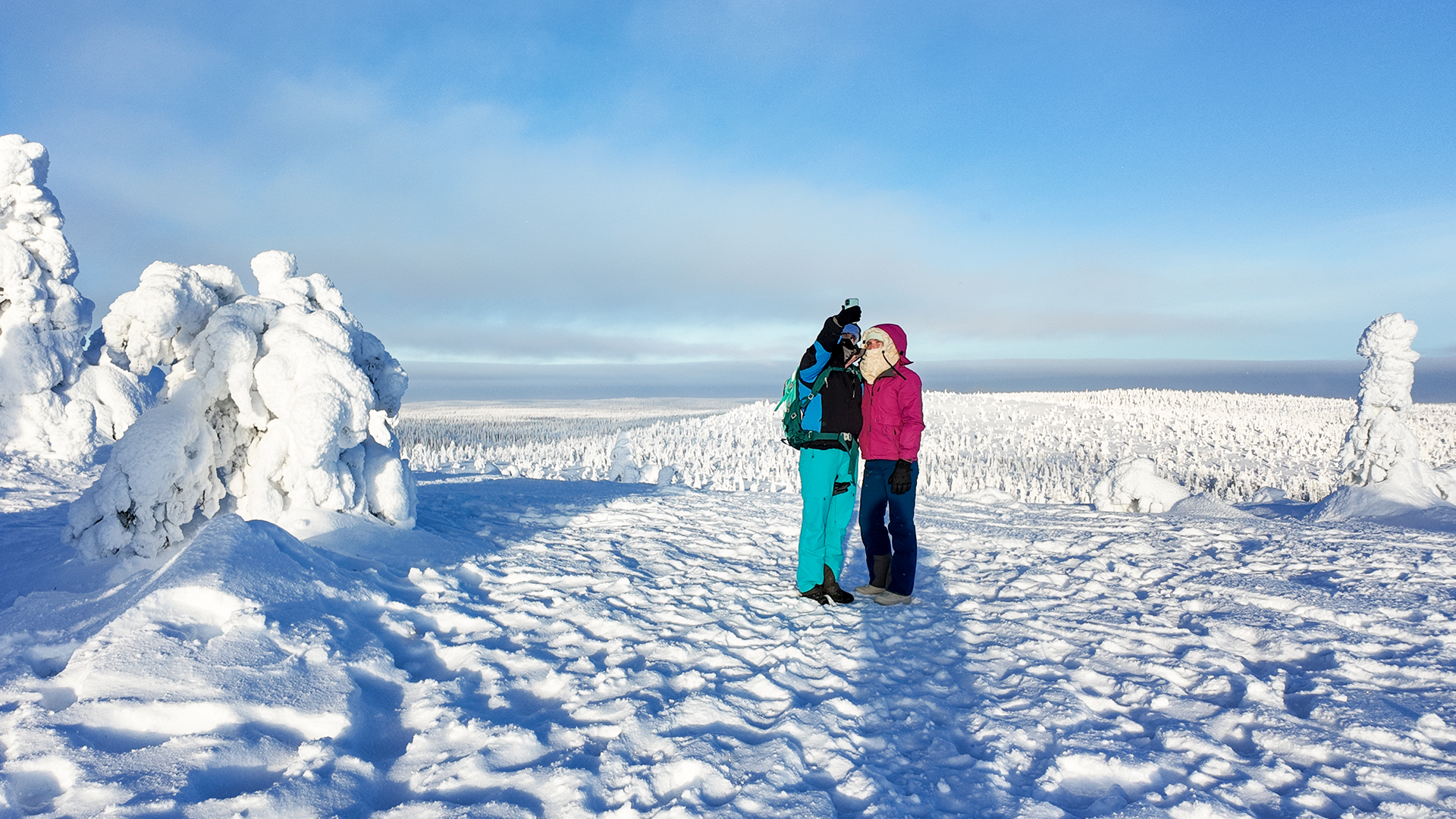 person riding on skis during winter surrounded by mountains