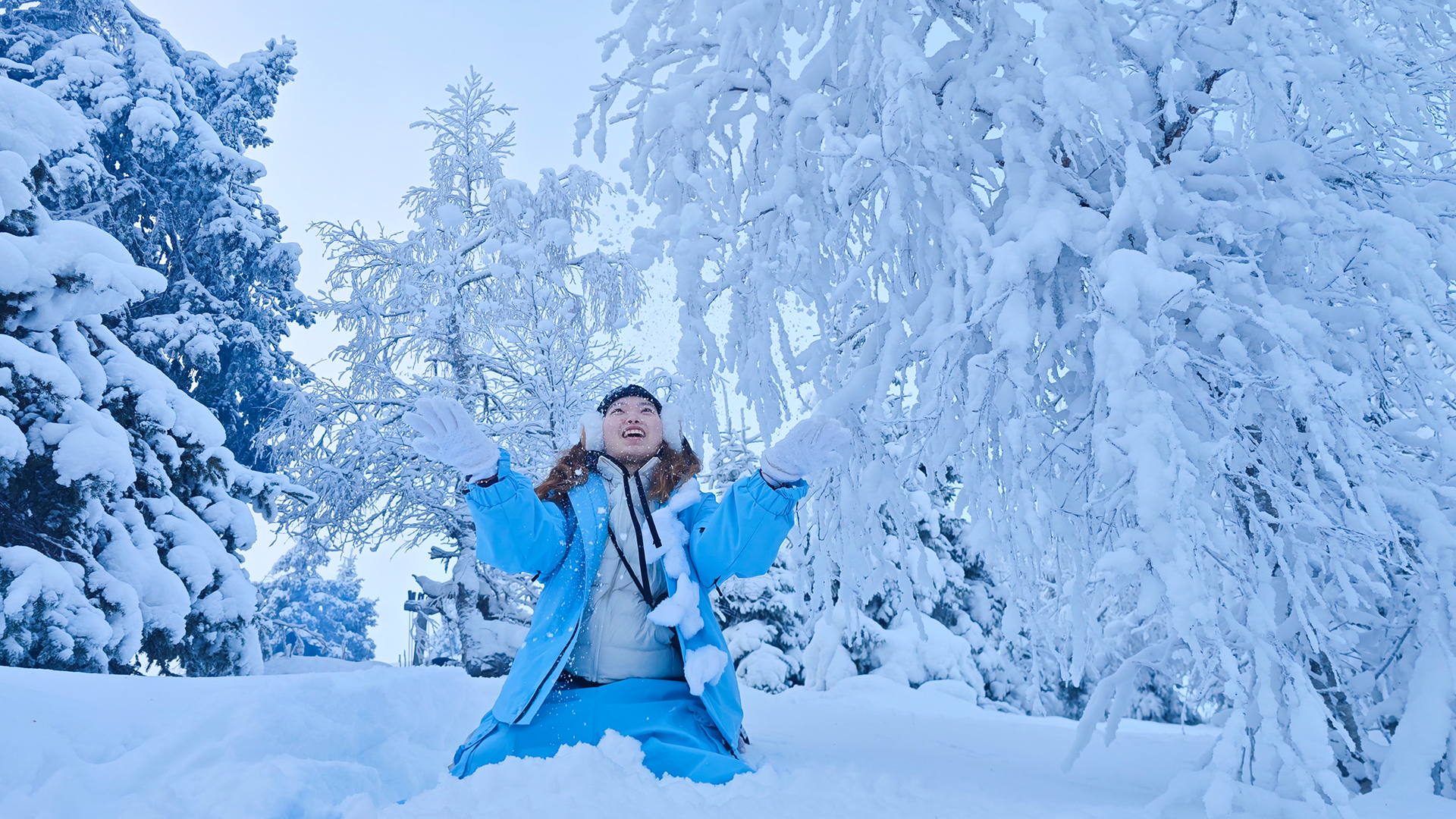 person riding on skis during winter surrounded by mountains