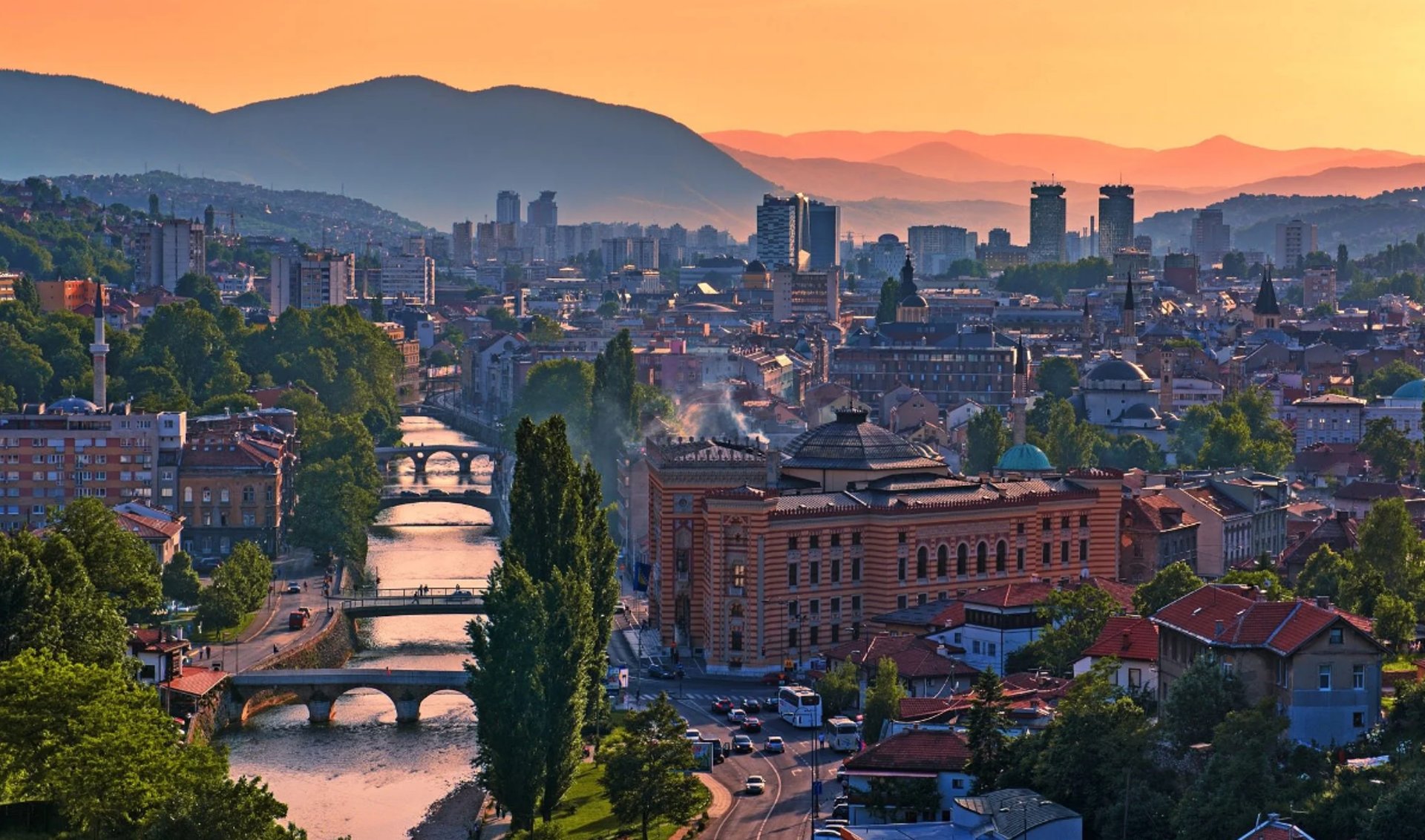 a bridge over a river with a building in the background