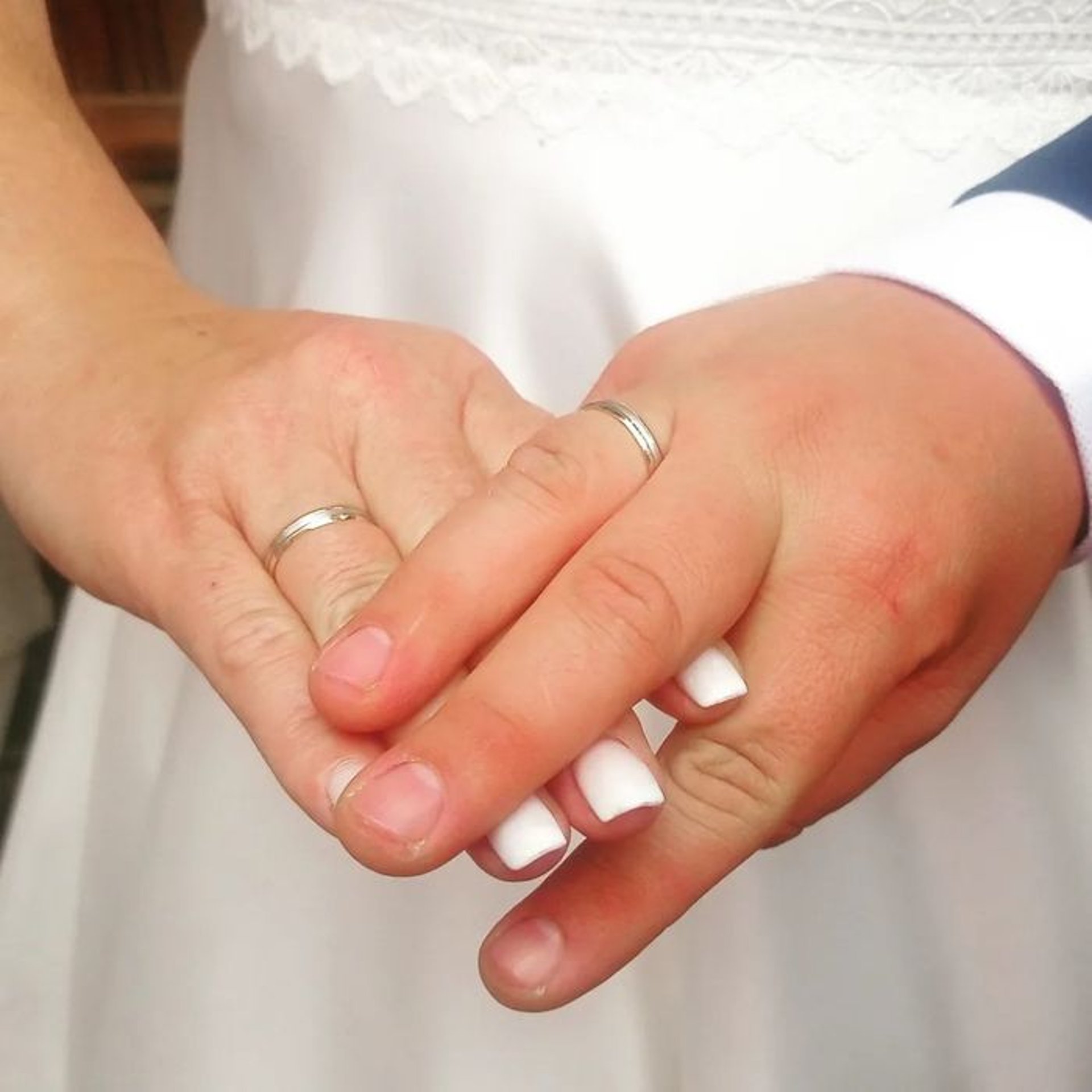 A close up of two people holding hands