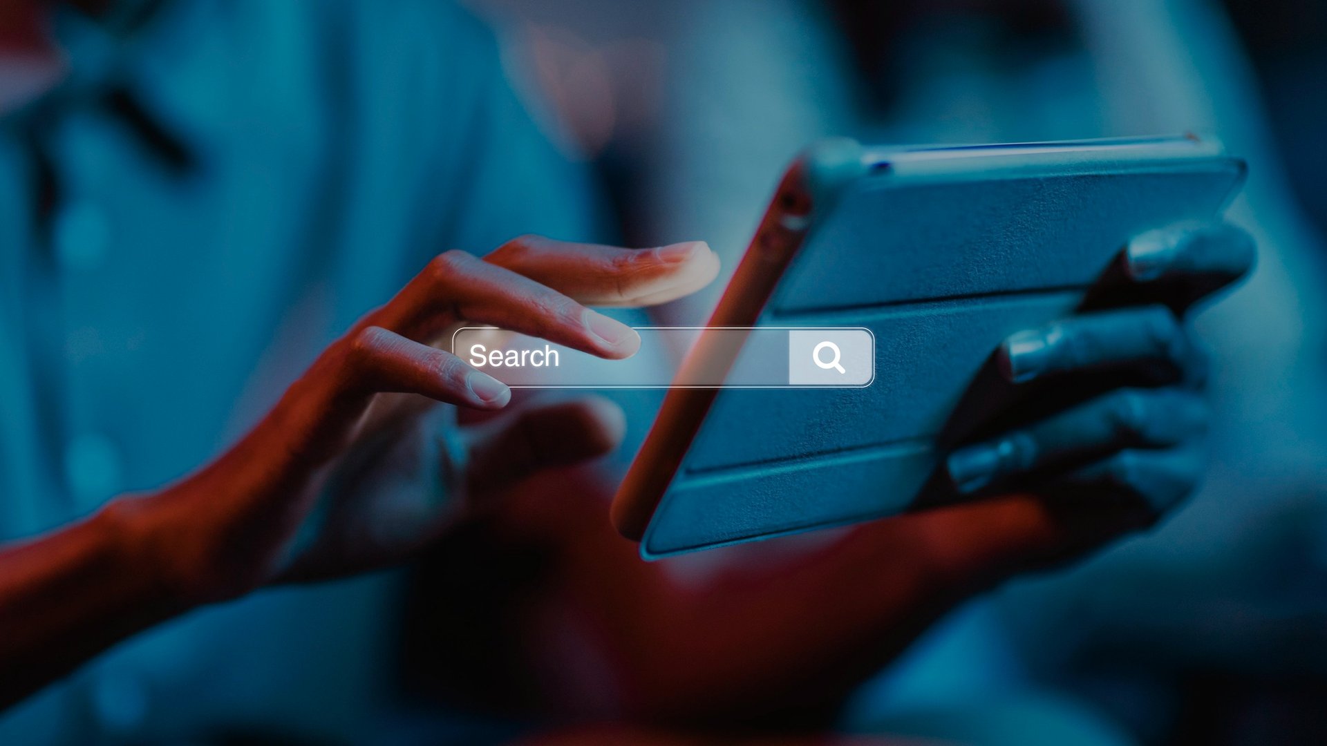 A smartphone on a laptop with coffee, notebook, and pen.