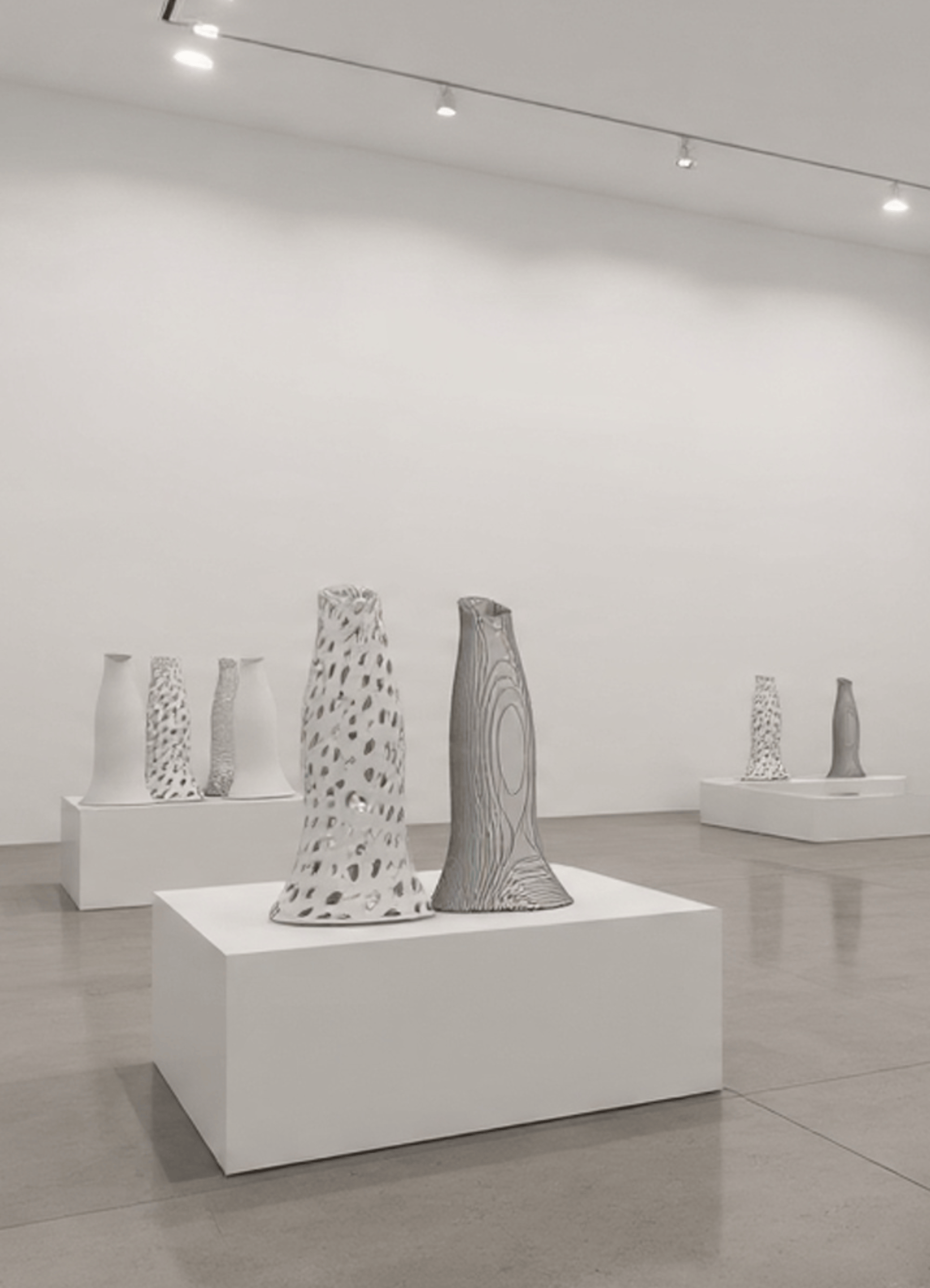 an abstract photo of a curved building with a blue sky in the background