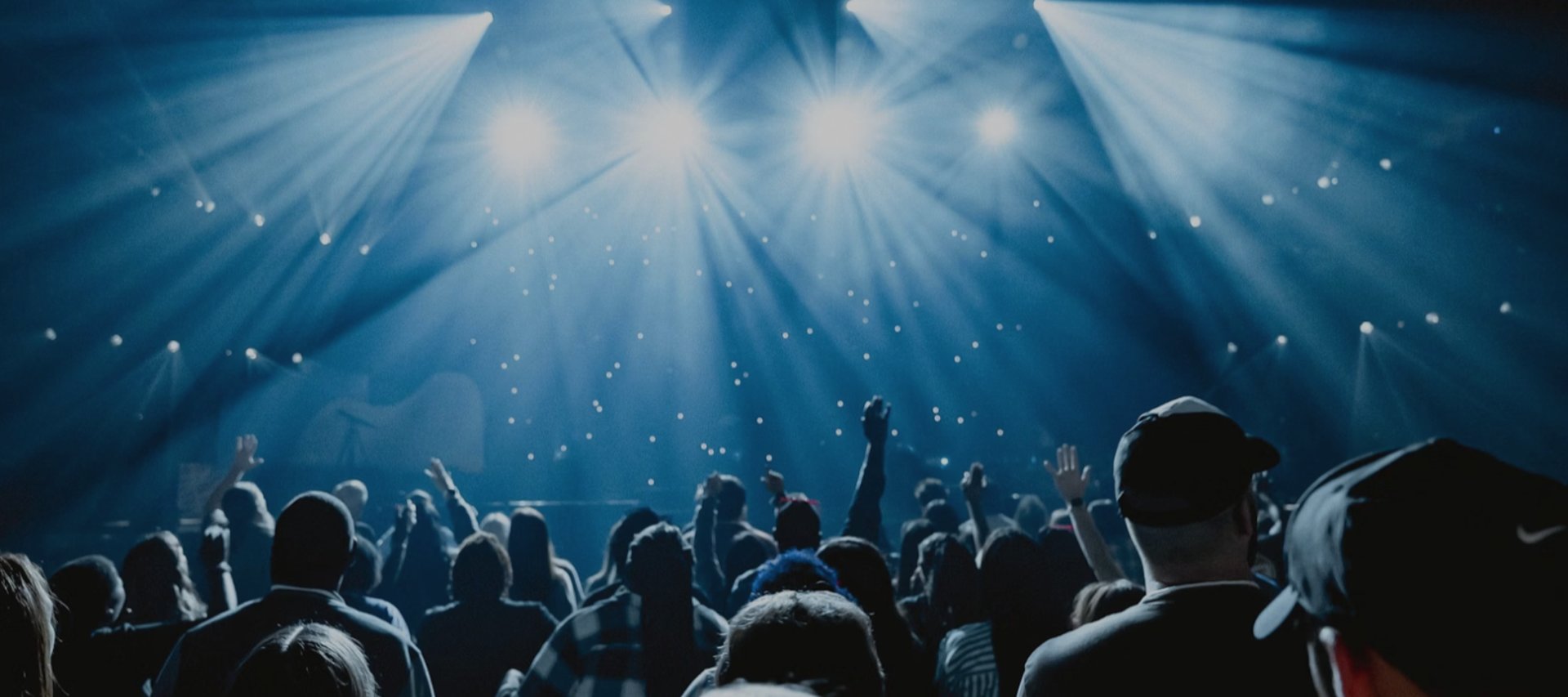 A large crowd of people in a dark room