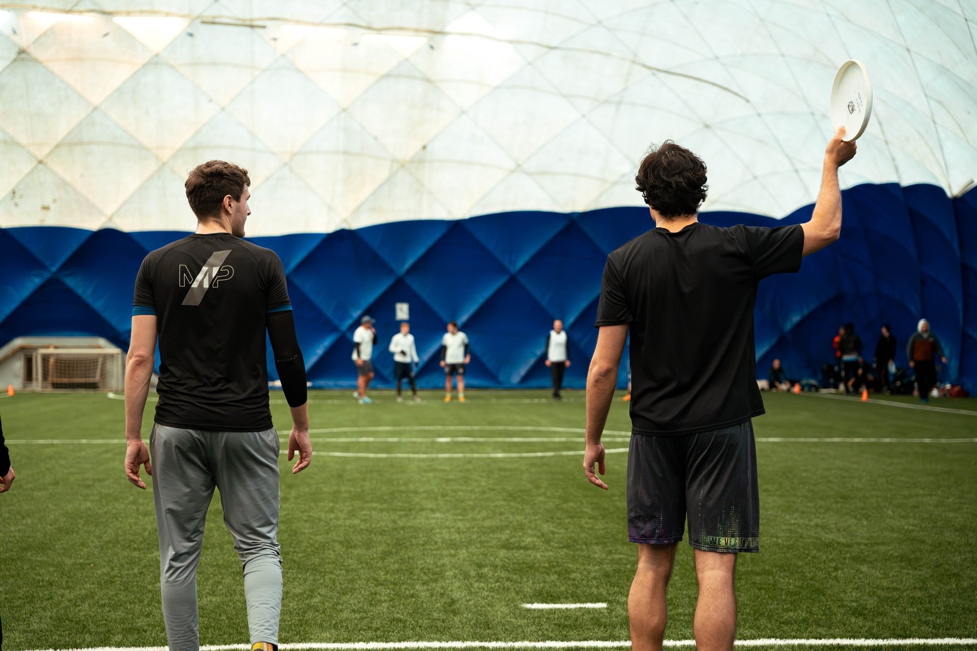 an abstract photo of a curved building with a blue sky in the background