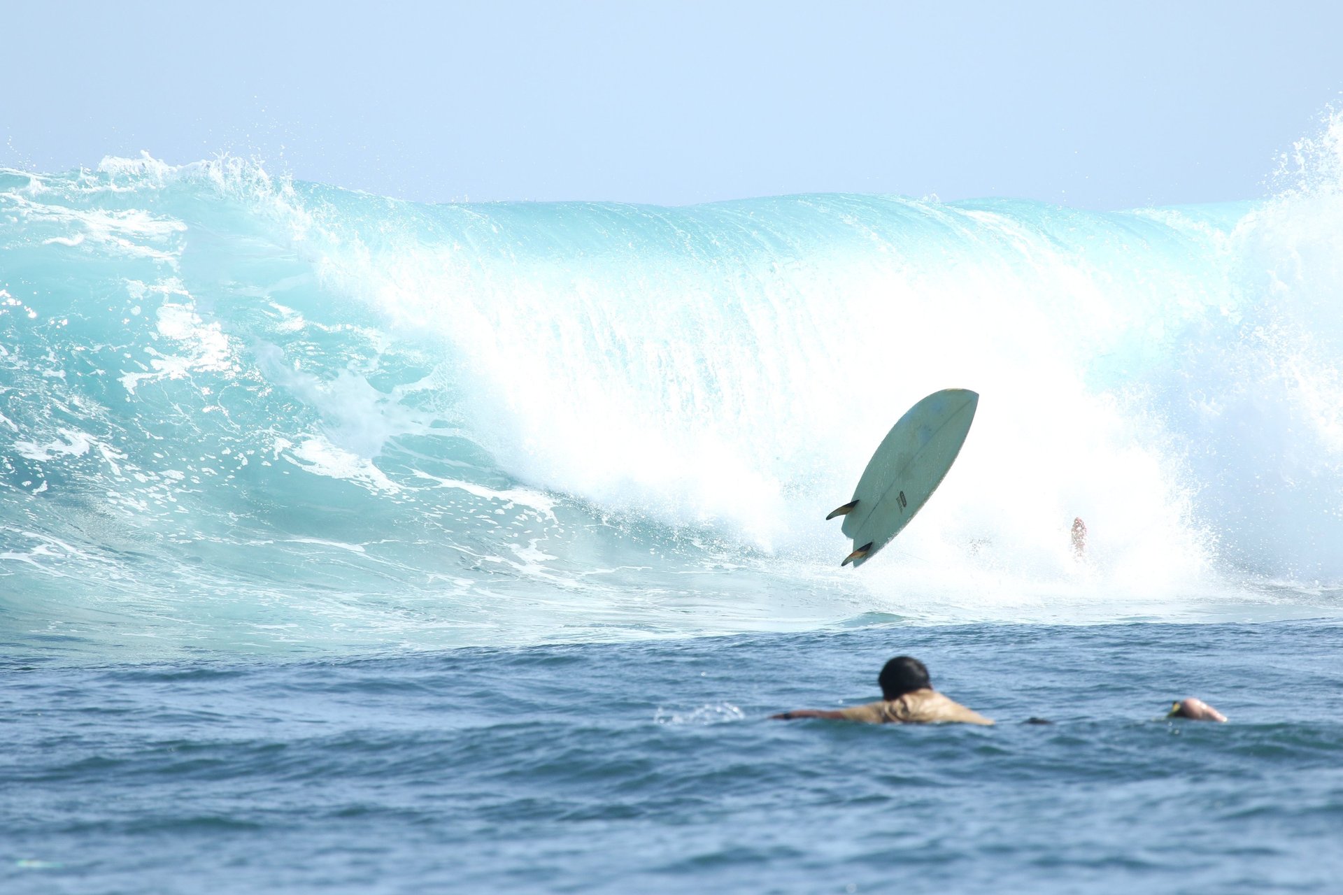 an abstract photo of a curved building with a blue sky in the background
