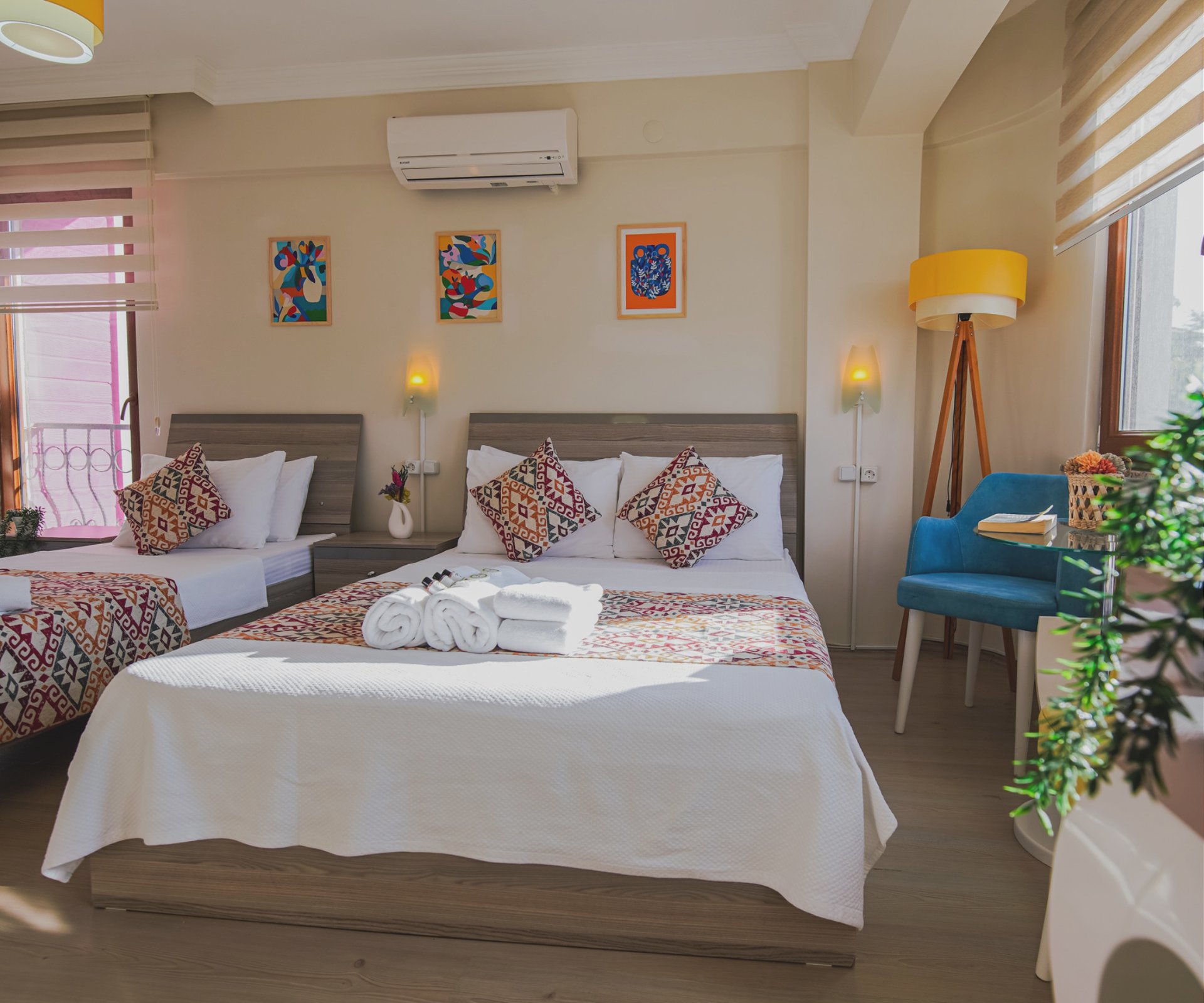 a group of people sitting on the edge of a cliff next to a body of