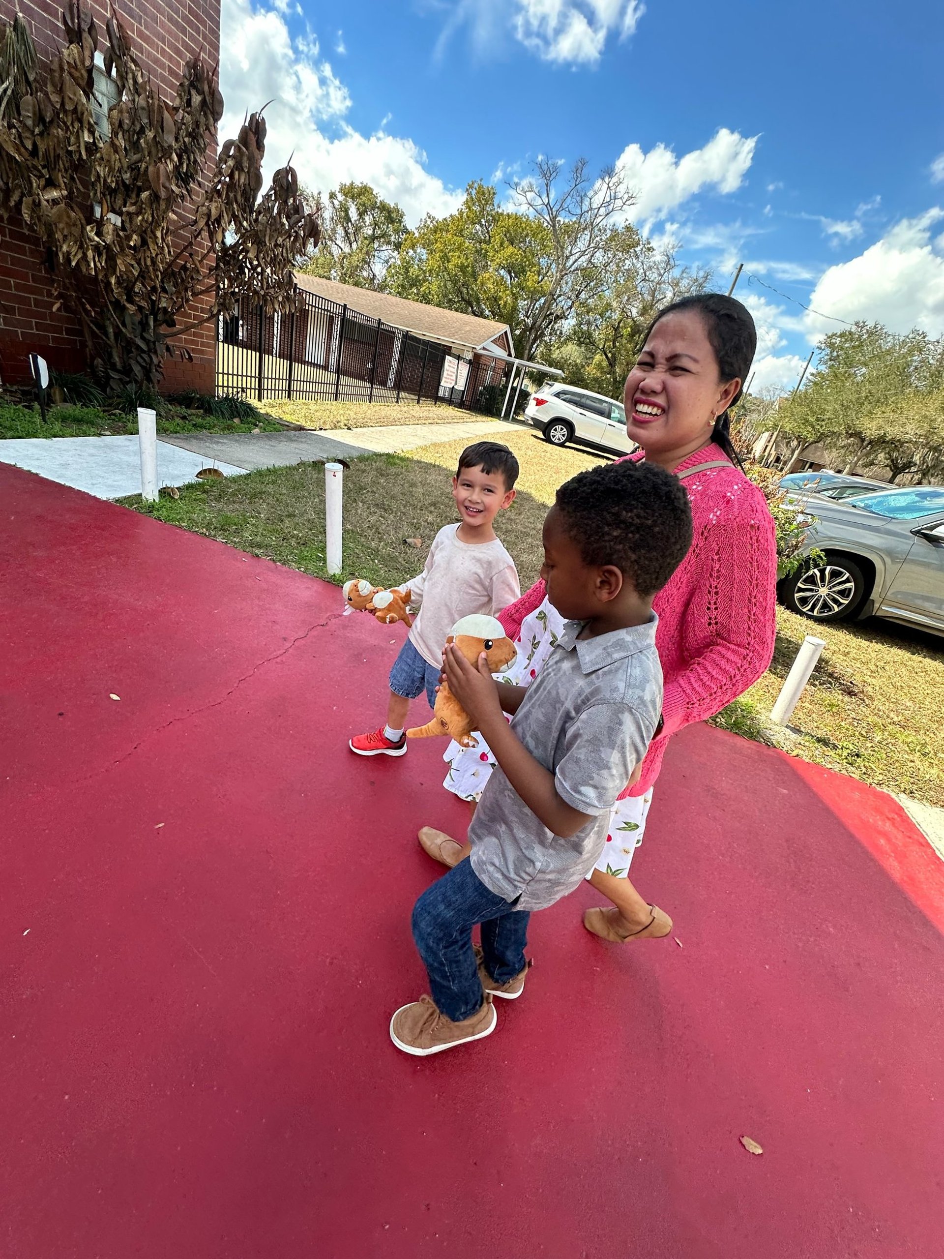 man in white dress shirt and black pants sitting on the sidewalk during daytime