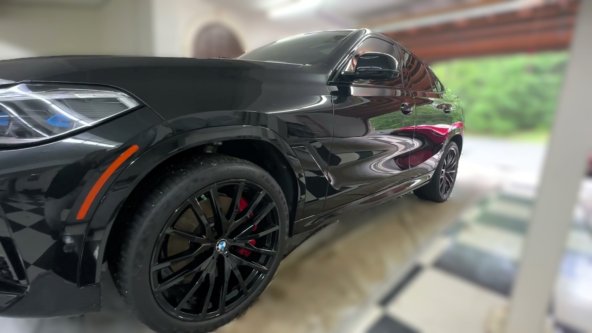 car detailing on exterior of black bmw suv