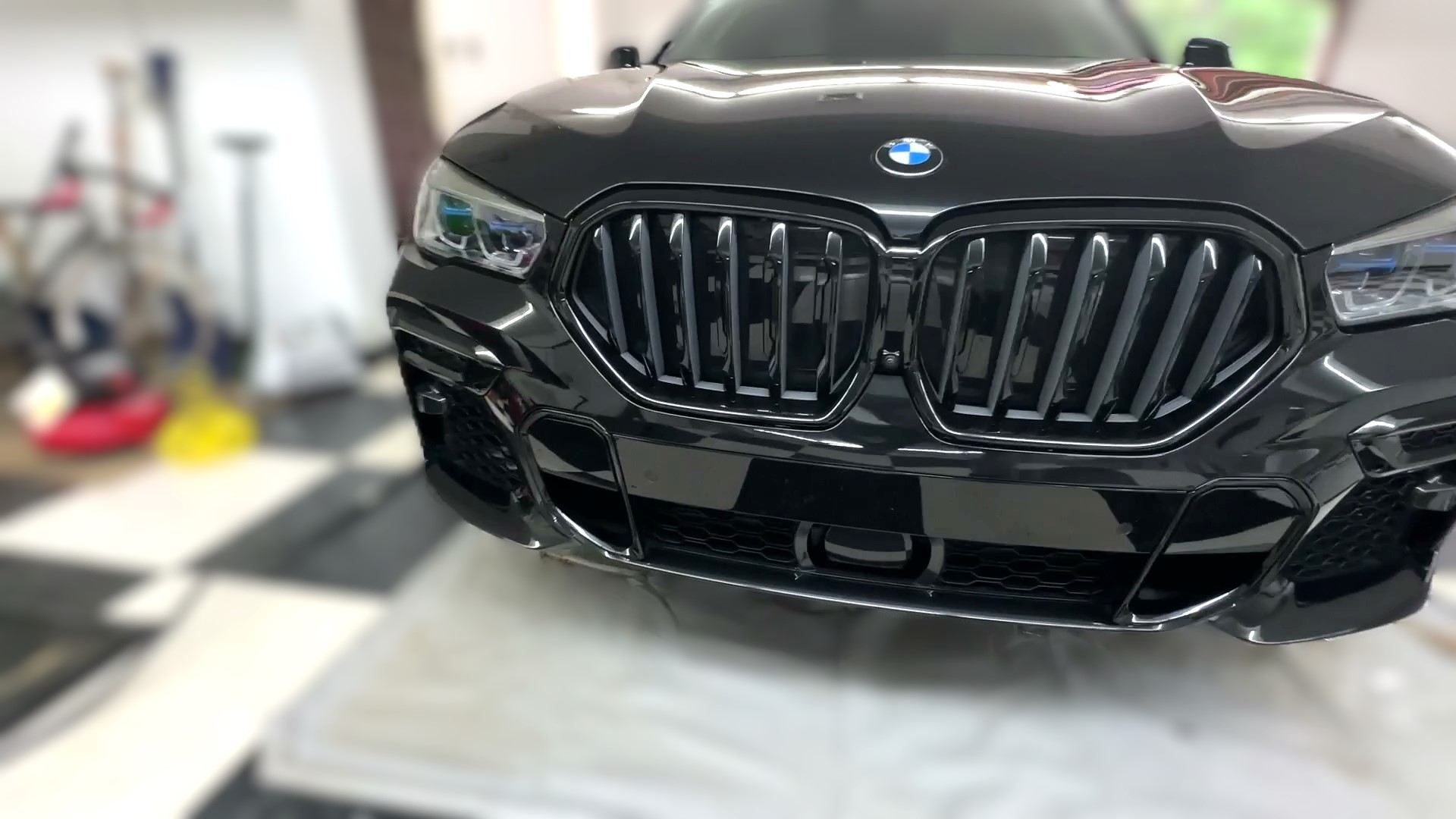 ceramic coating after mobile detailing on a black luxury suv showing glossy reflections