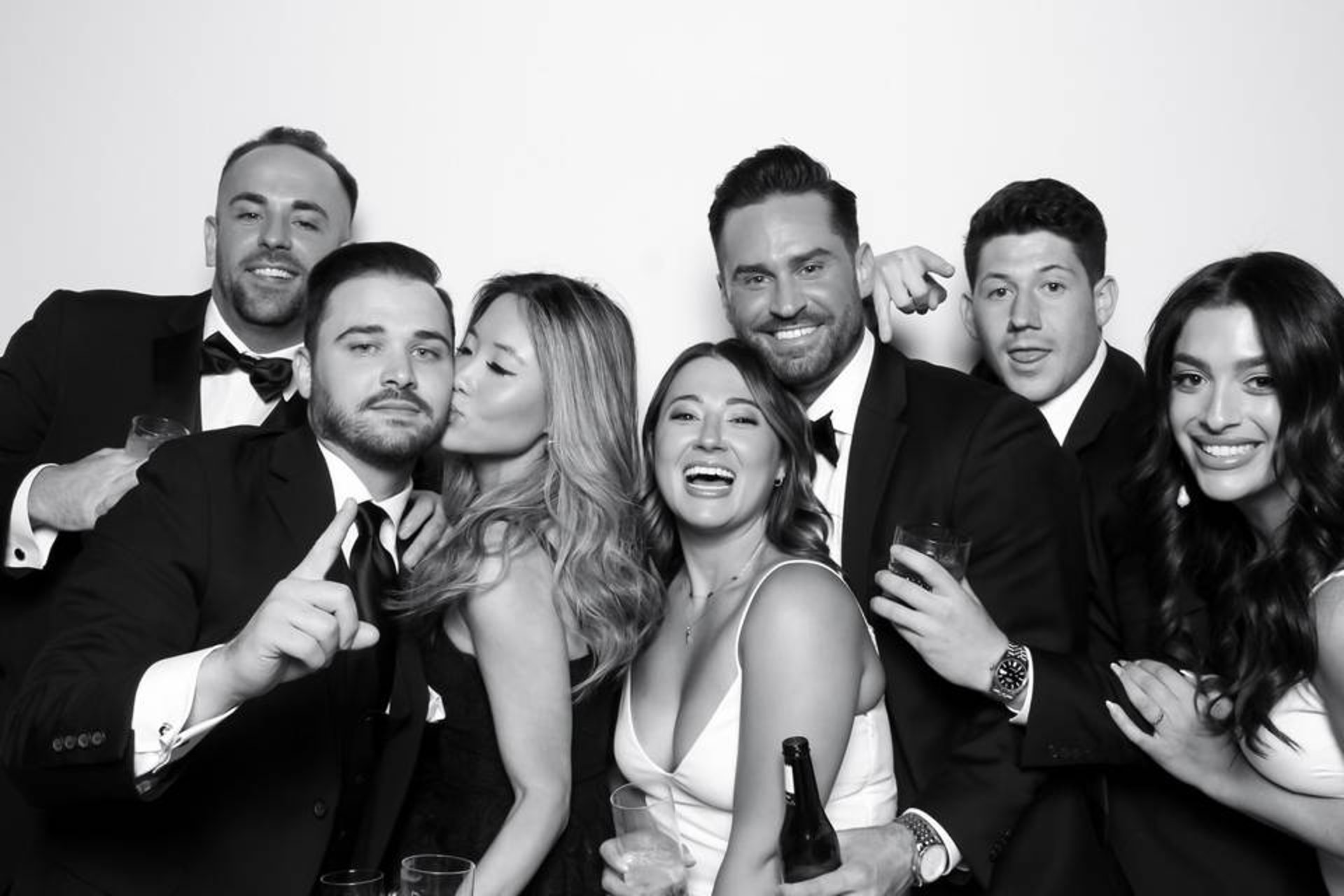 People gathered around a photobooth in a park.