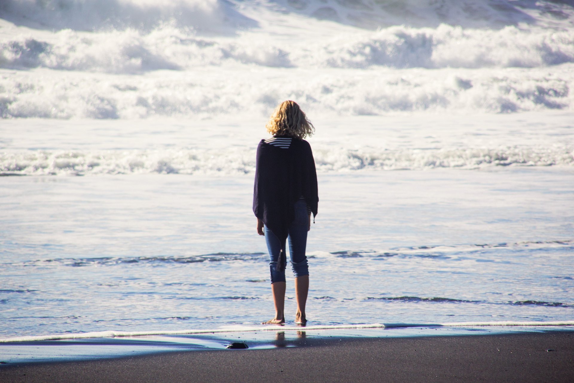 an abstract photo of a curved building with a blue sky in the background