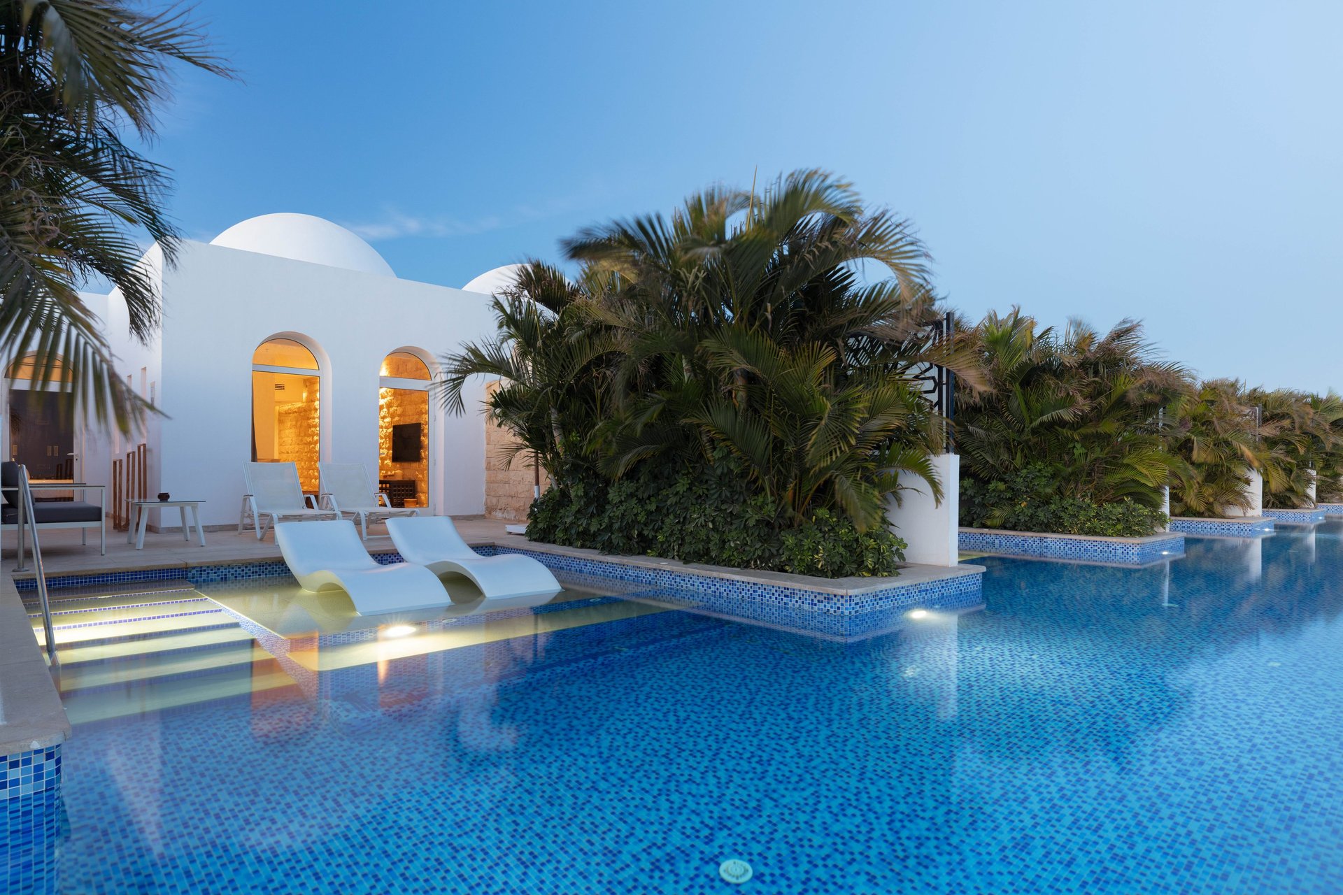 an abstract photo of a curved building with a blue sky in the background