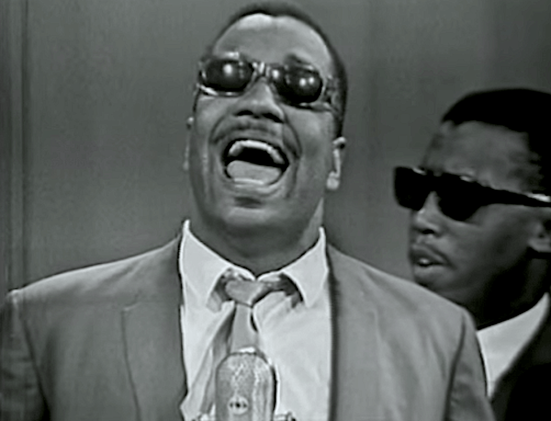 an abstract photo of a curved building with a blue sky in the background