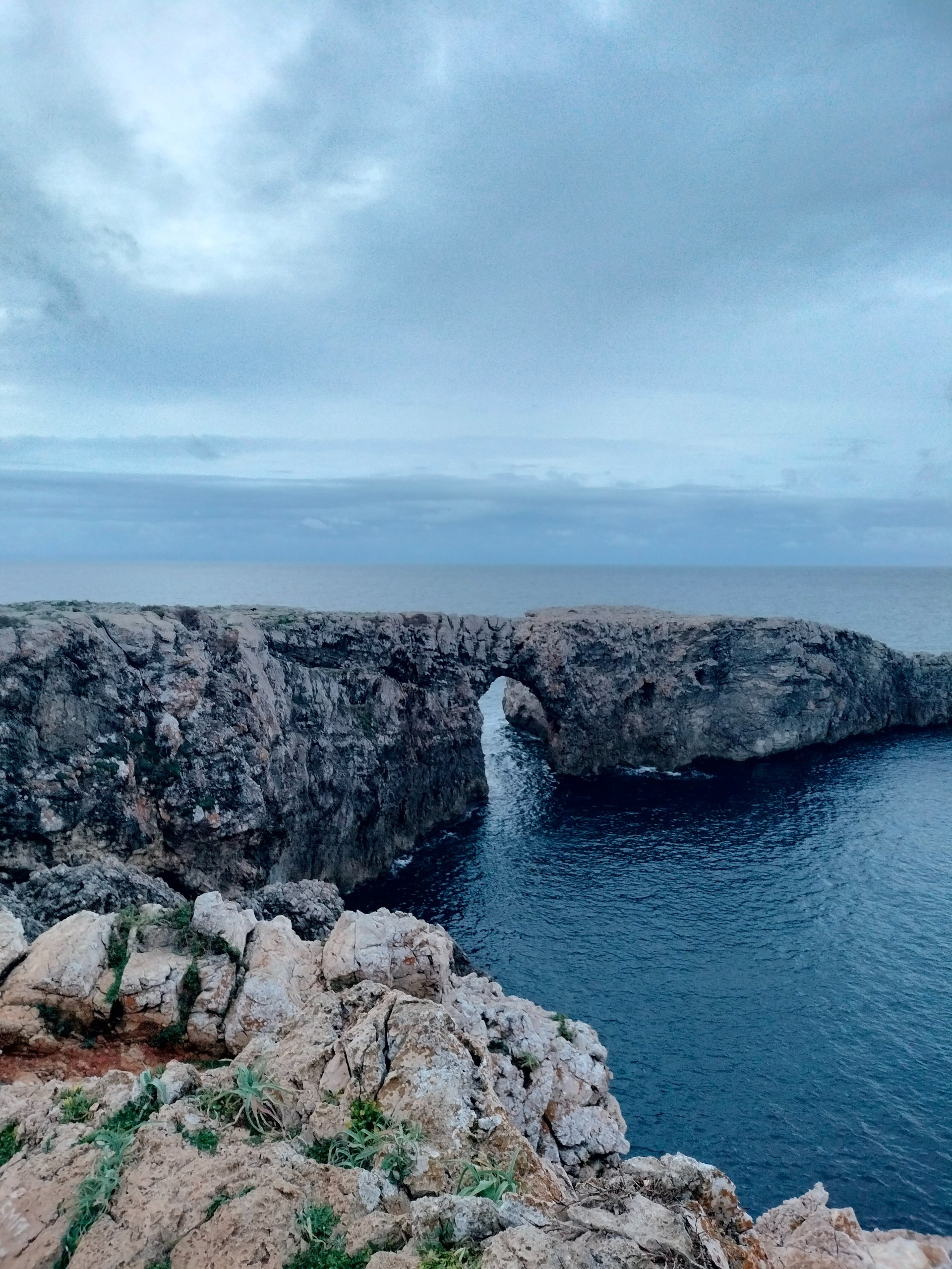 an abstract photo of a curved building with a blue sky in the background