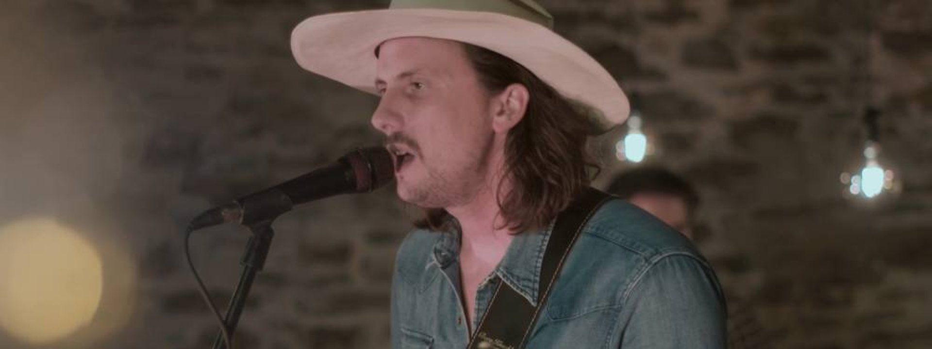 Lead singer of Mosaic performing soulful Americana vocals at a wedding in Devon