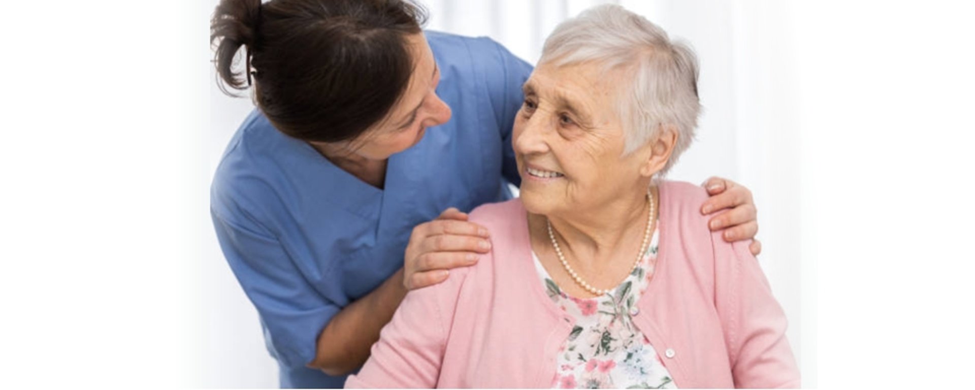 Caregiver assisting elderly couple with coloring