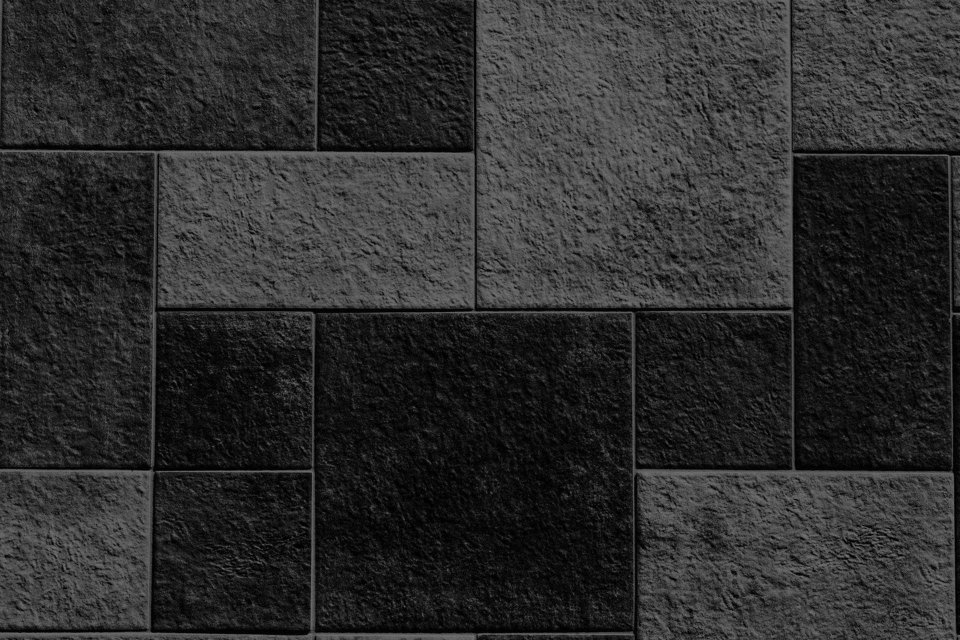 a close up of a black wall with a white object in the middle of it