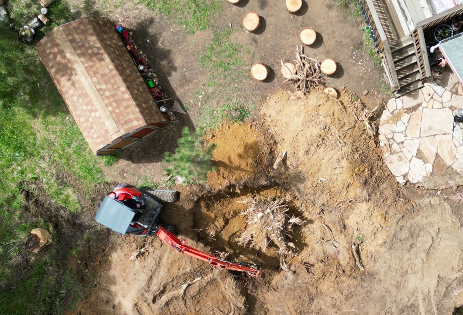 Aerial view of foundation excavation and land clearing progress.