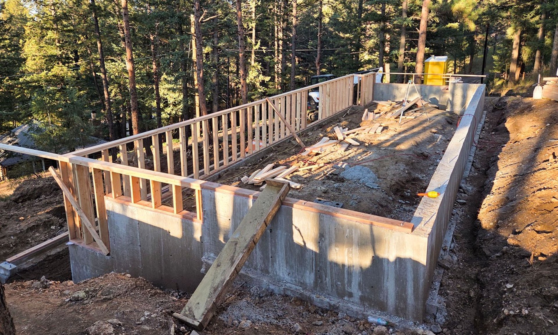 Cured concrete foundation walls and forms for a large-scale residential project.