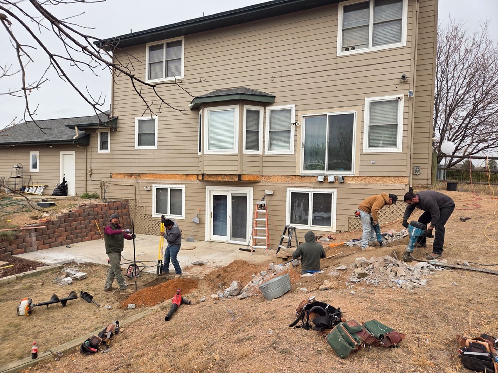 Construction site preparation and initial framing for a large-scale residential deck project.