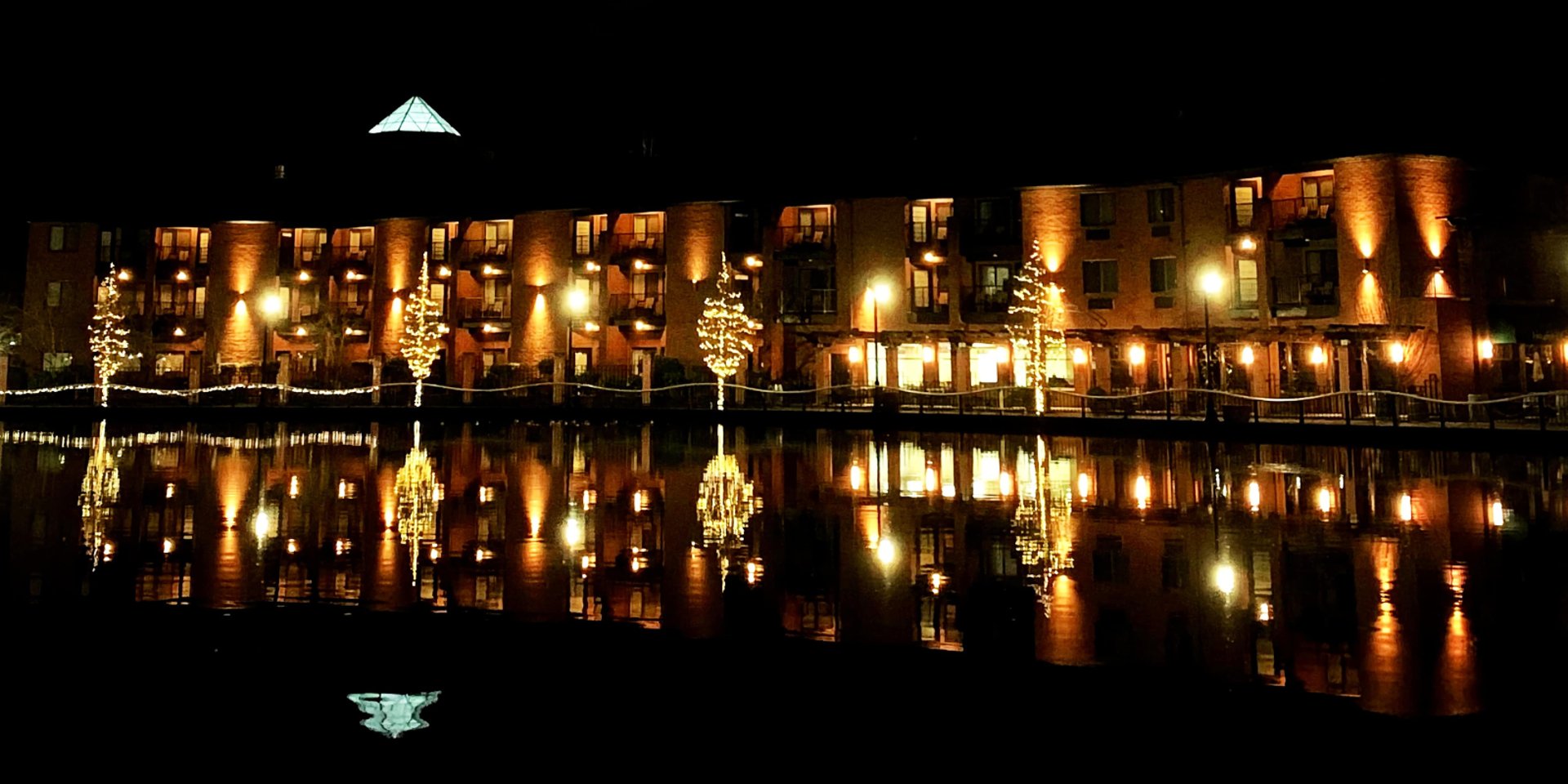 city with high rise buildings near mountain during sunset