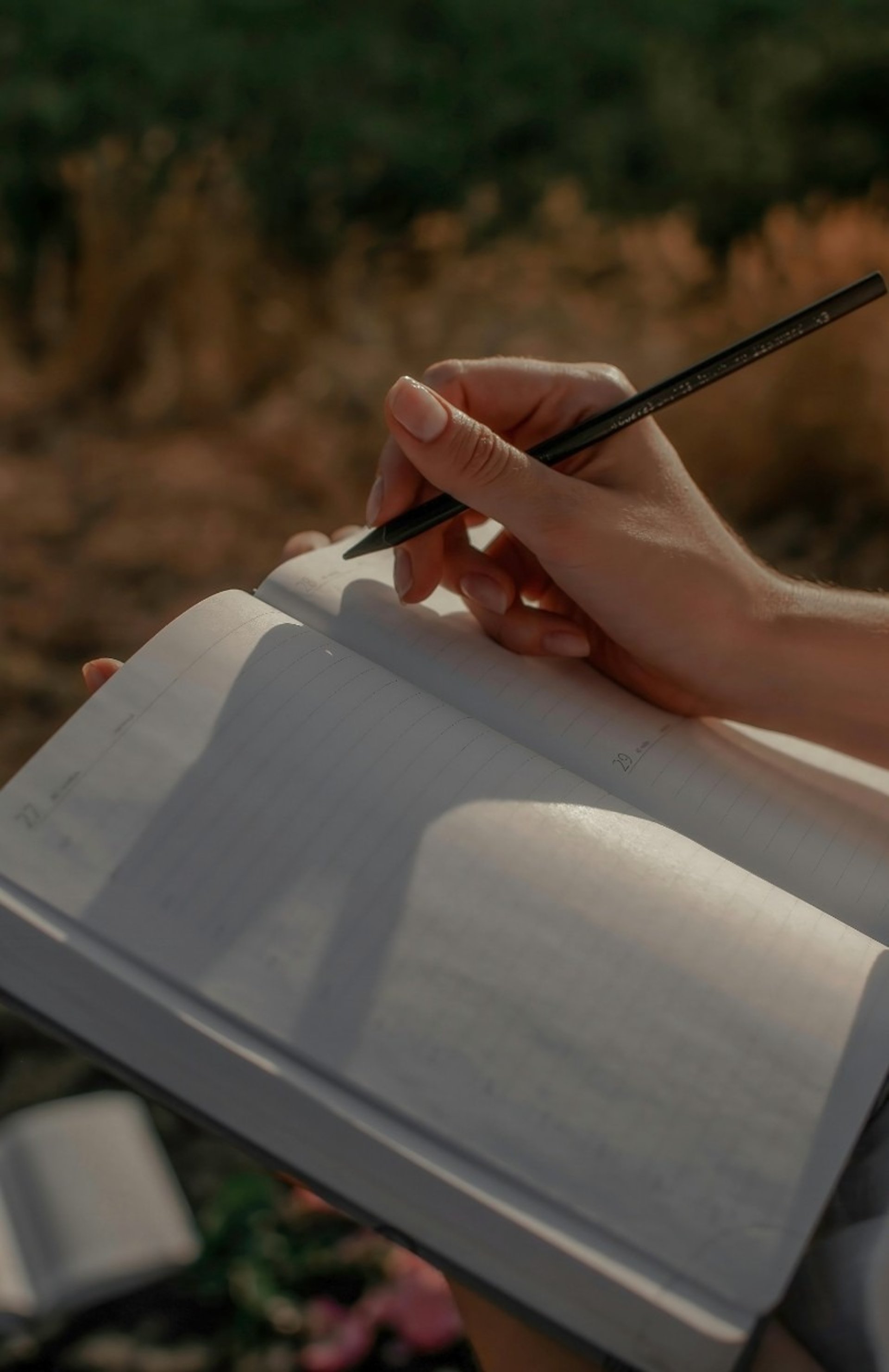 a woman sitting in a field of grass