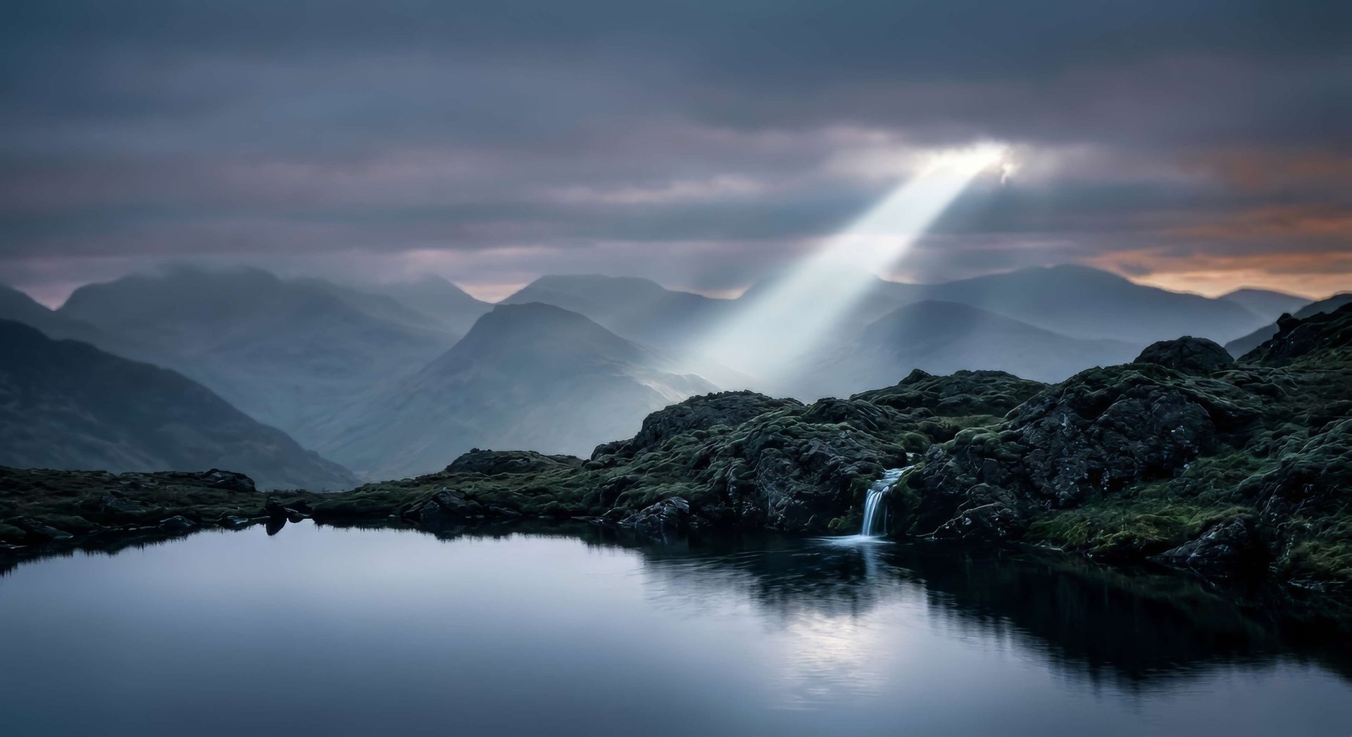 Ray of sunlight over a mountain lake symbolizing inner peace and mental clarity by Ricardas Miliusis