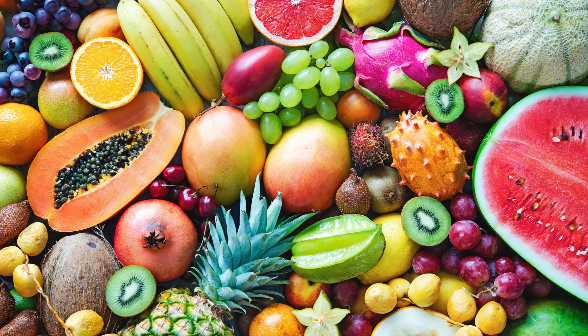 red apple fruit beside green apple and yellow fruit on brown woven basket