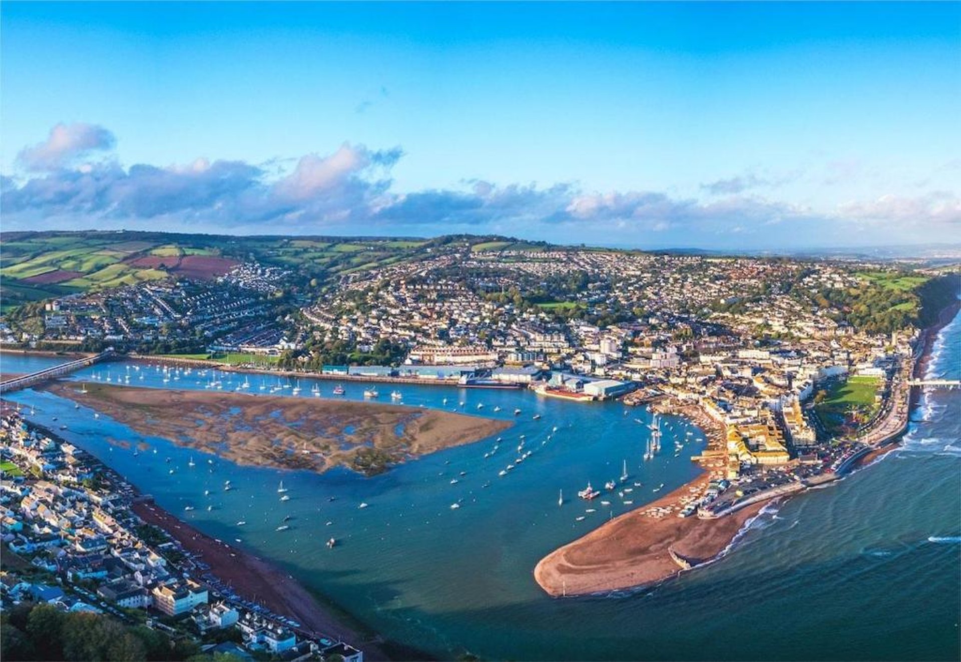 woman wearing yellow long-sleeved dress under white clouds and blue sky during daytime