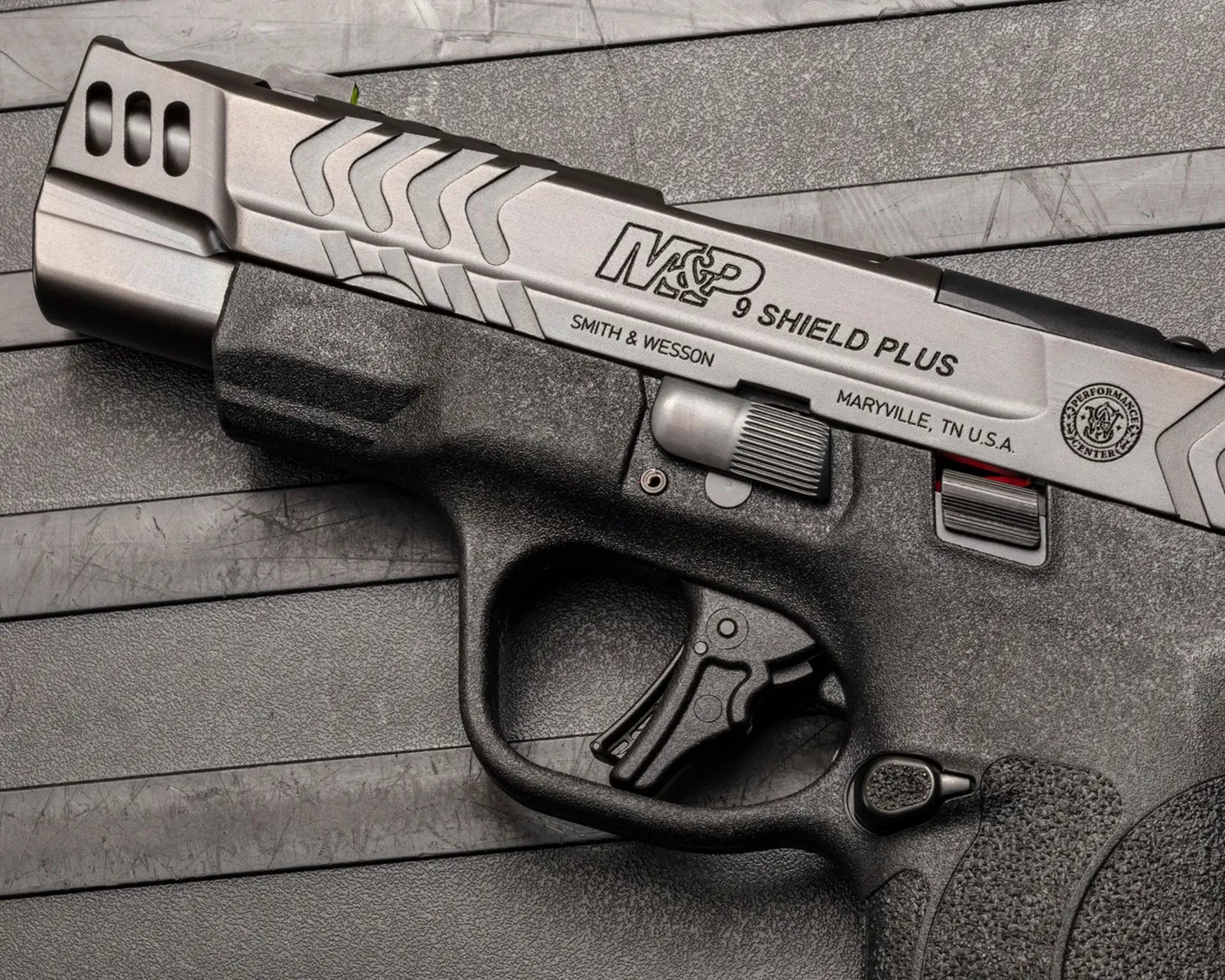 a close up of a gun on a black surface