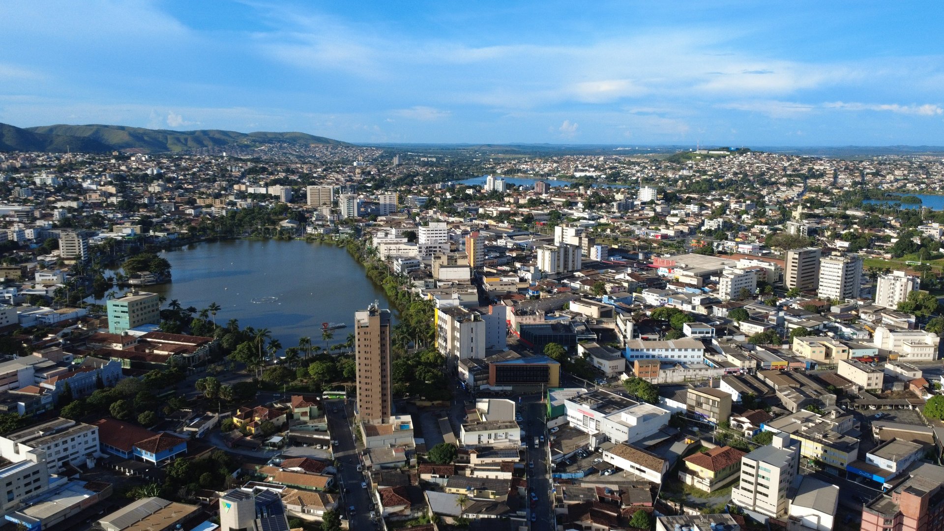 woman wearing yellow long-sleeved dress under white clouds and blue sky during daytime