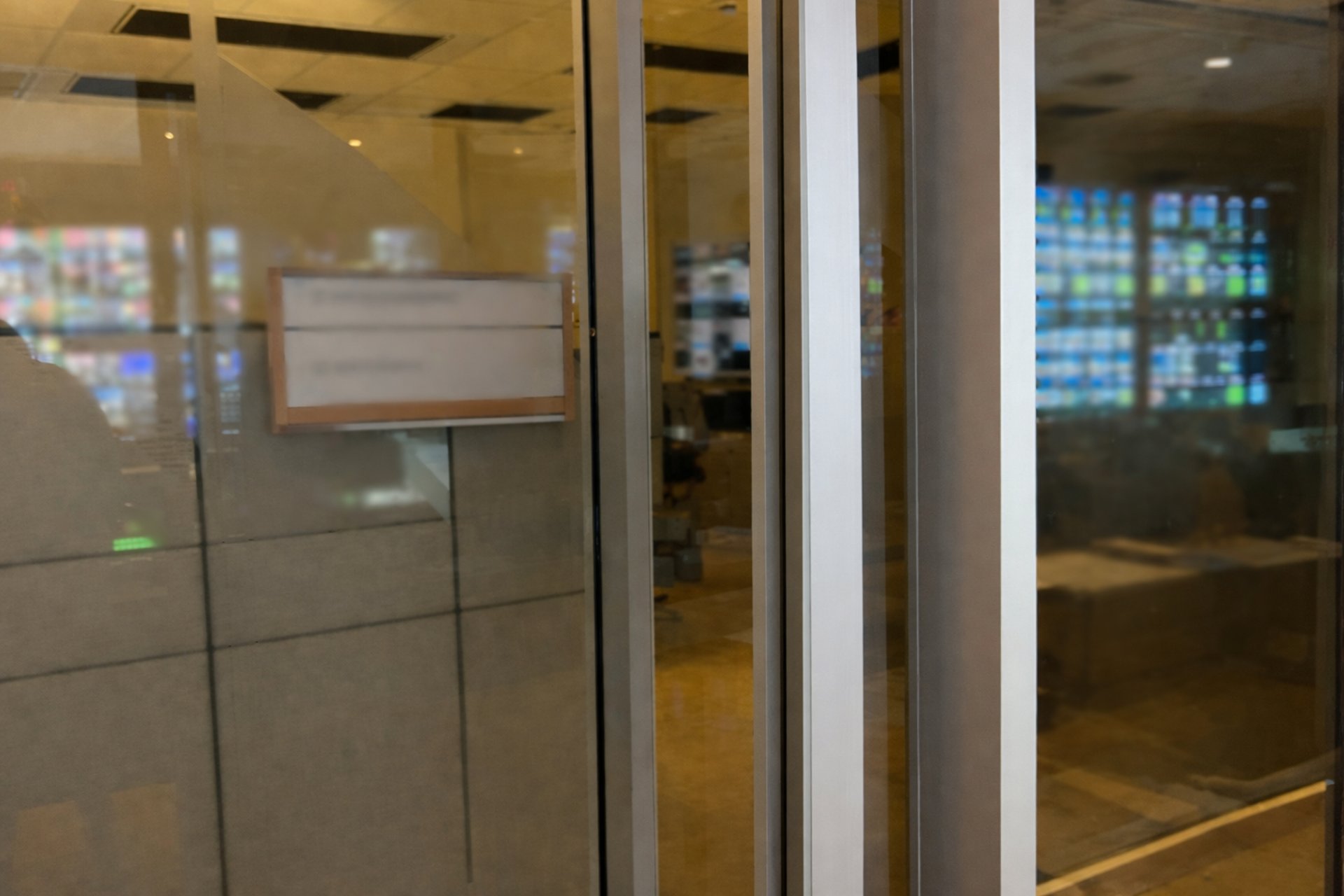 Secure glass entrance to a commercial building representing contact and security services in Ottawa.