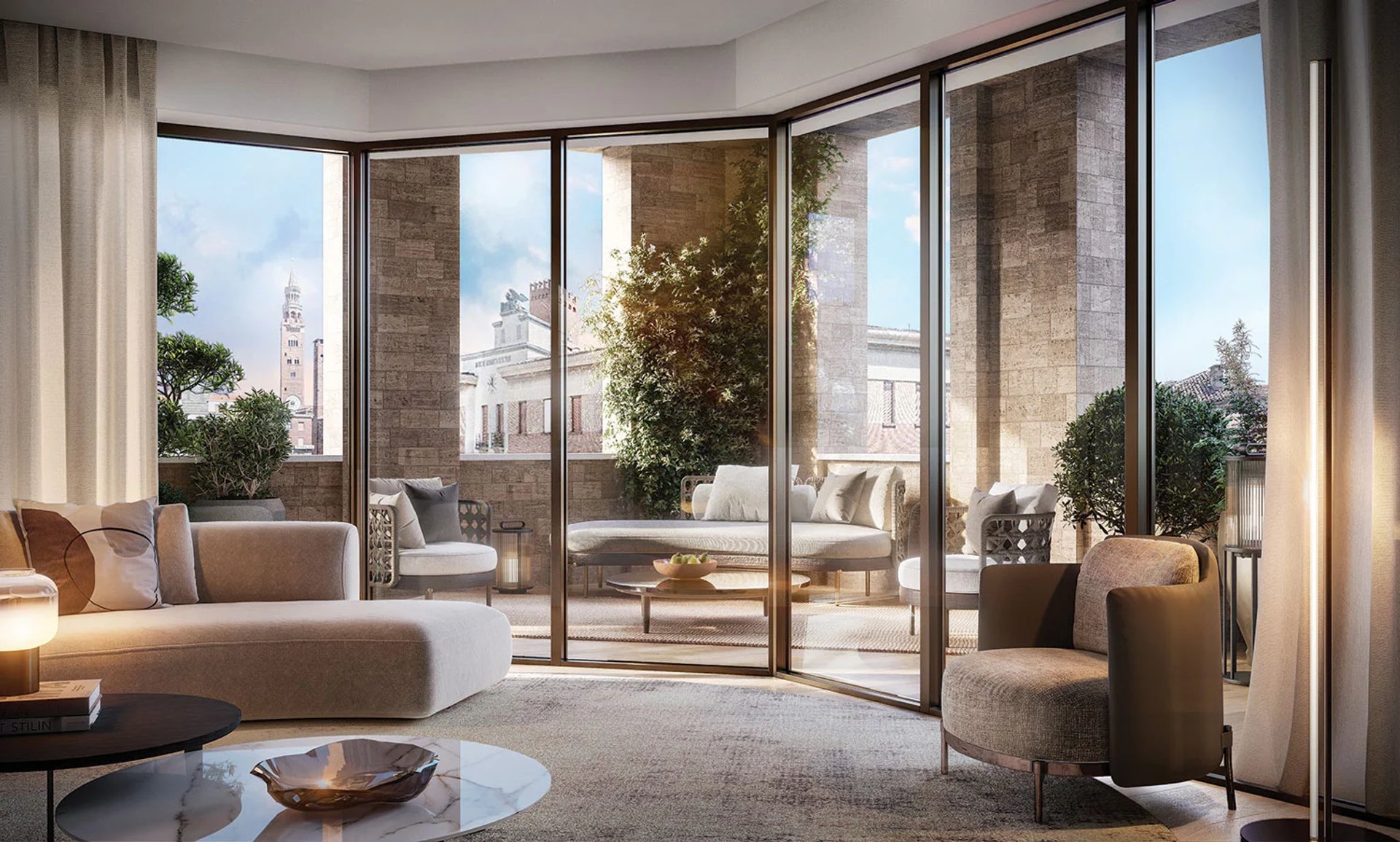 Ampio terrazzo loggiato di Palazzo CorteVerdi a Cremona: vetrate panoramiche firmate Stefano Boeri con vista Torrazzo.