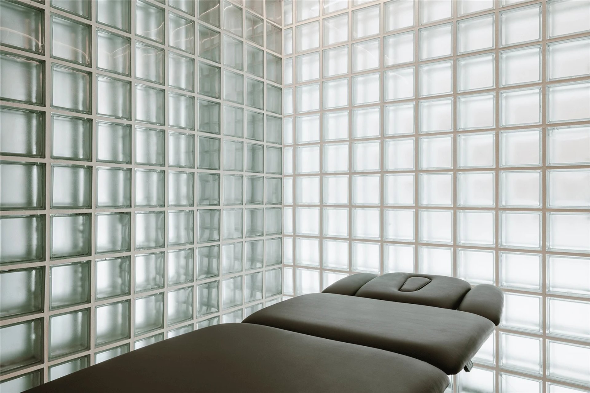 an abstract photo of a curved building with a blue sky in the background