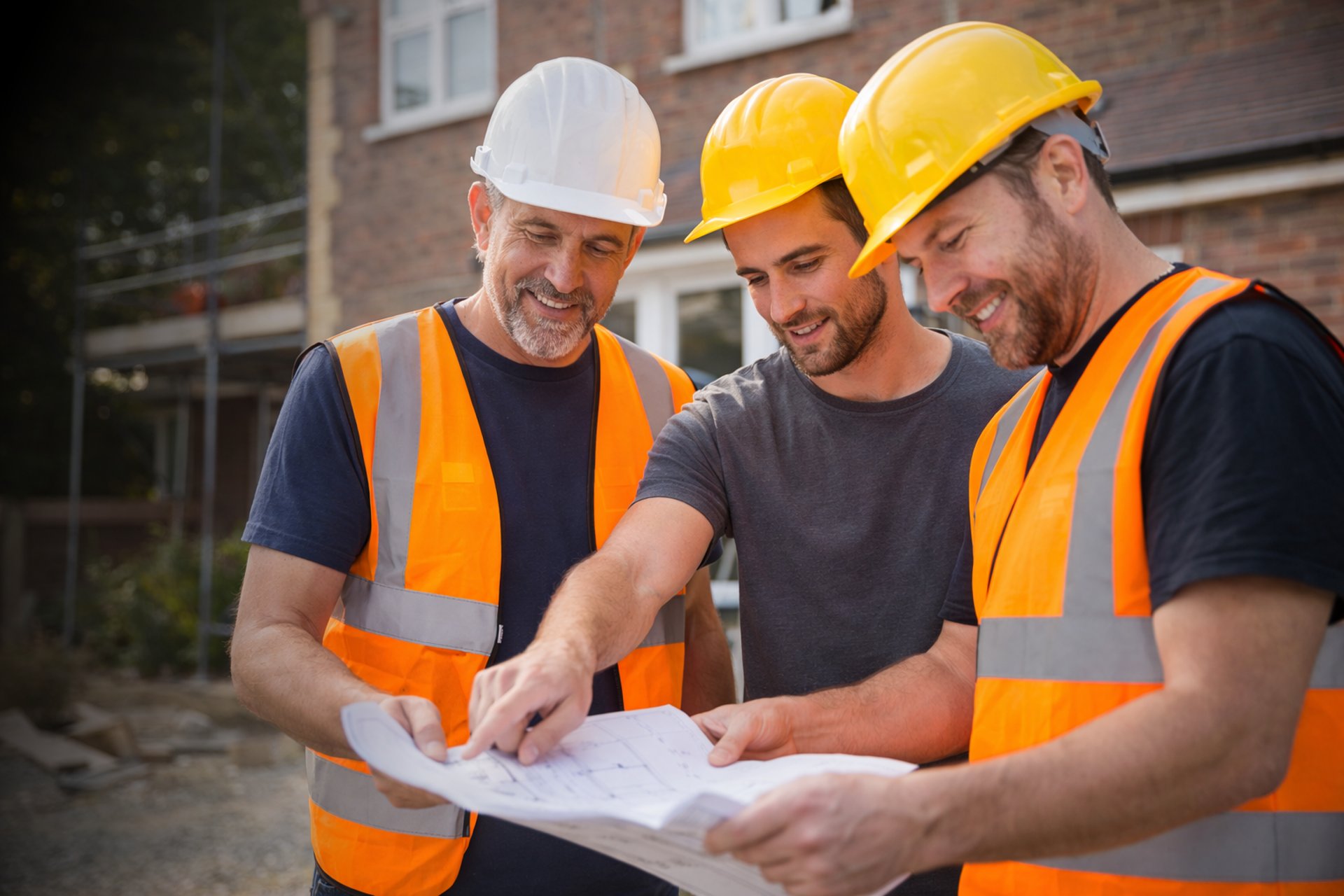 T.LE Contracting builder showing blueprints to a family during a Brighton home renovation.