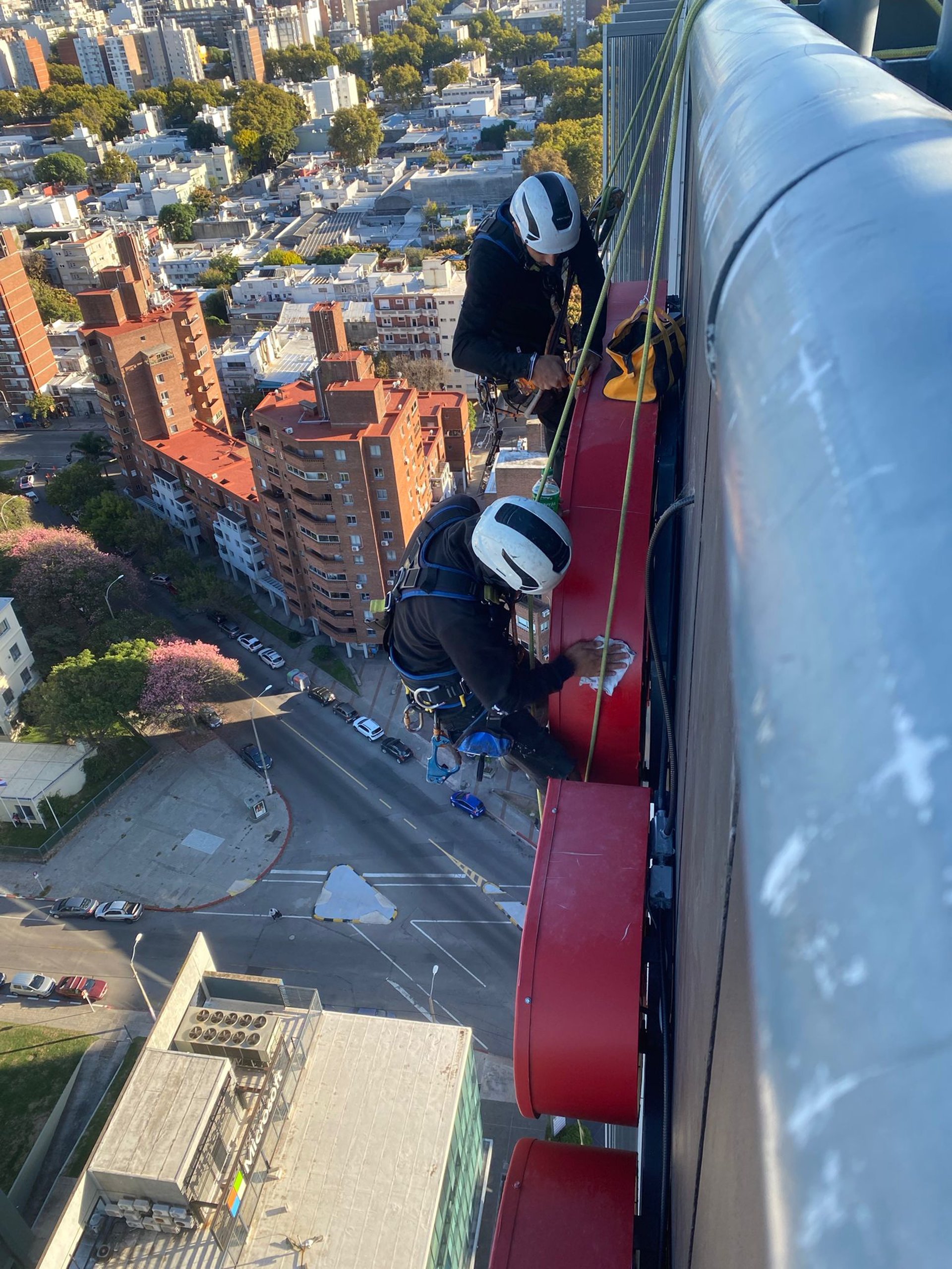 a man climbing up the side of a tall building