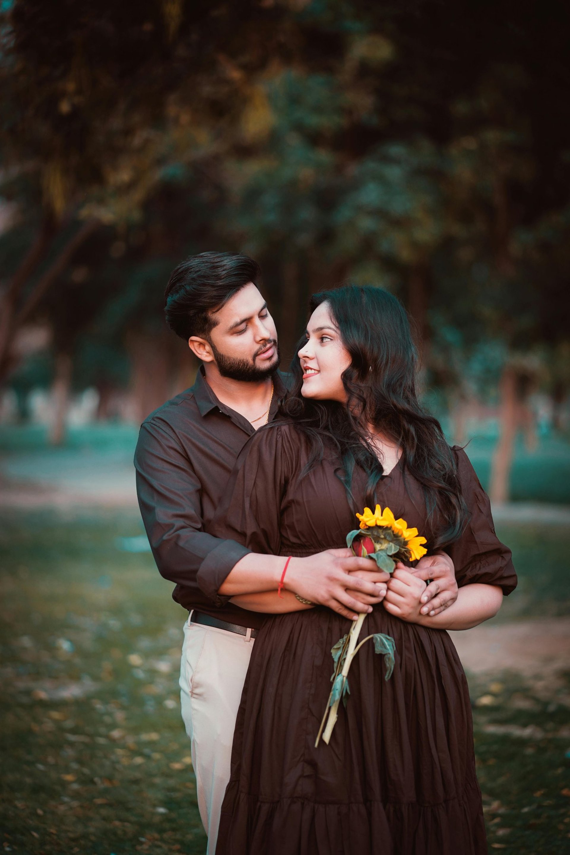 man in black suit and woman in white wedding dress