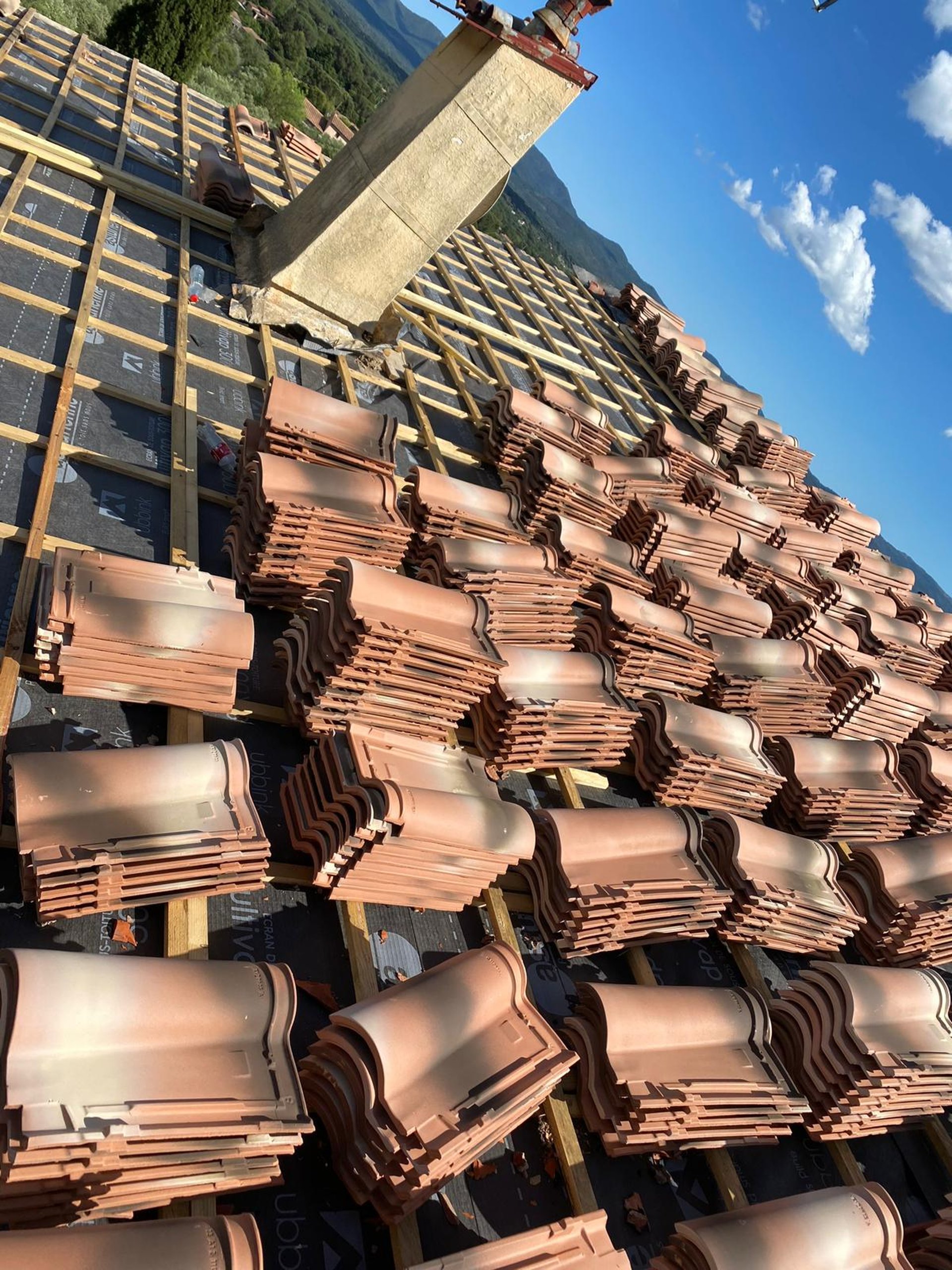 a person wearing blue gloves and holding a hammer