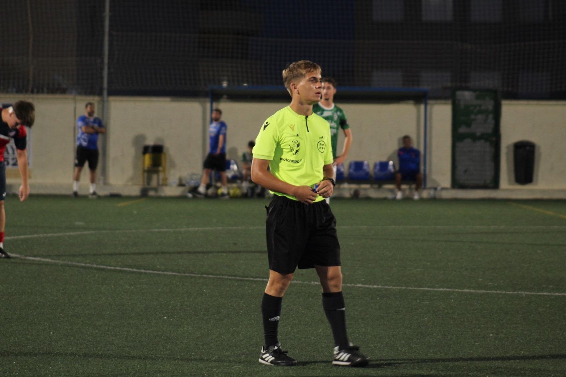 a man sitting on the edge of a fountain