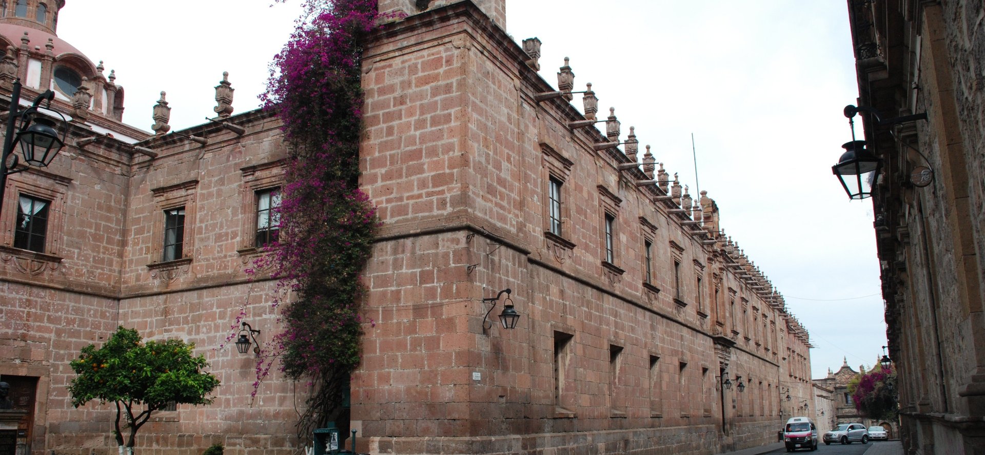 woman wearing yellow long-sleeved dress under white clouds and blue sky during daytime