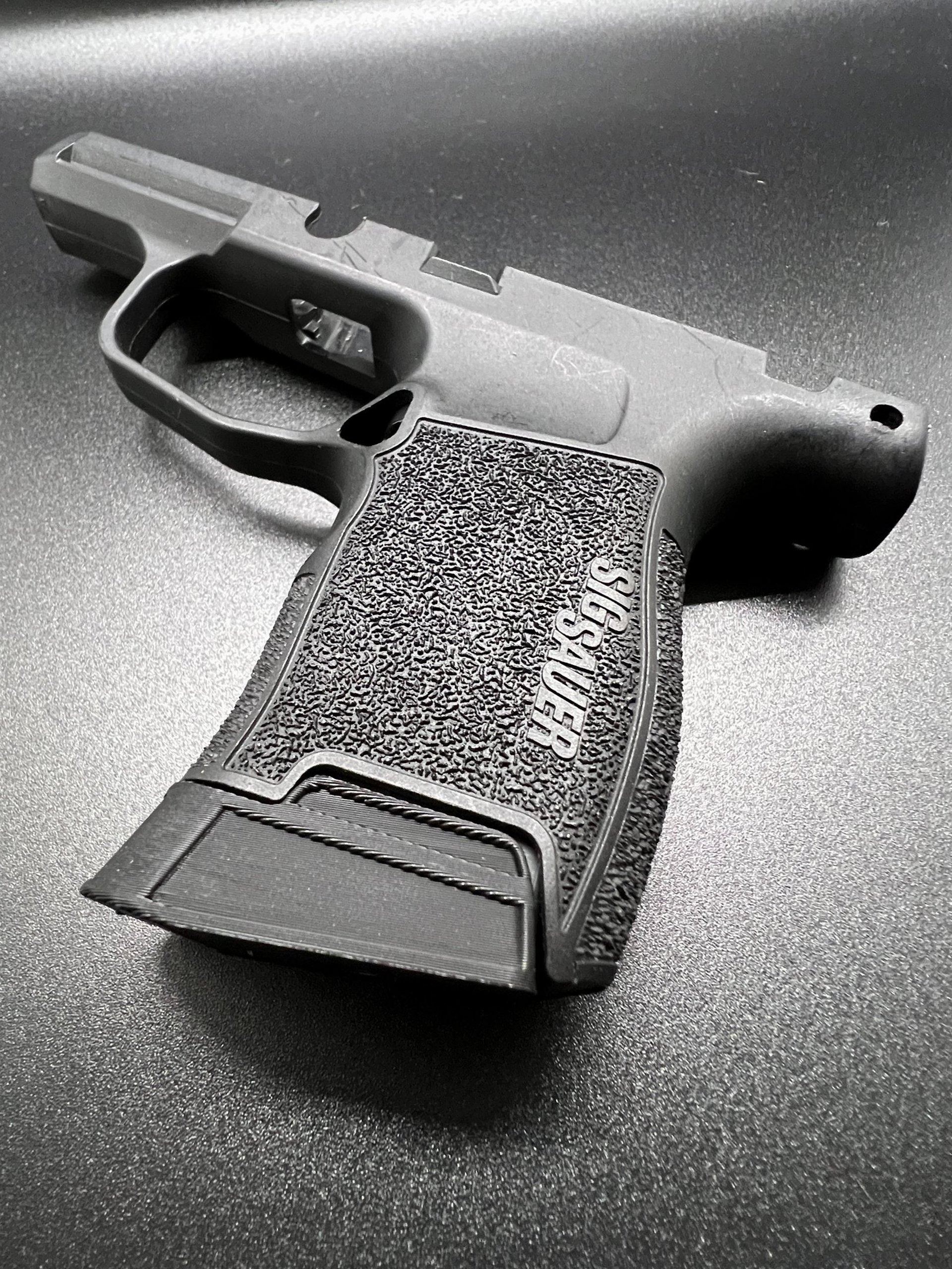 three gray bullets on brown surface