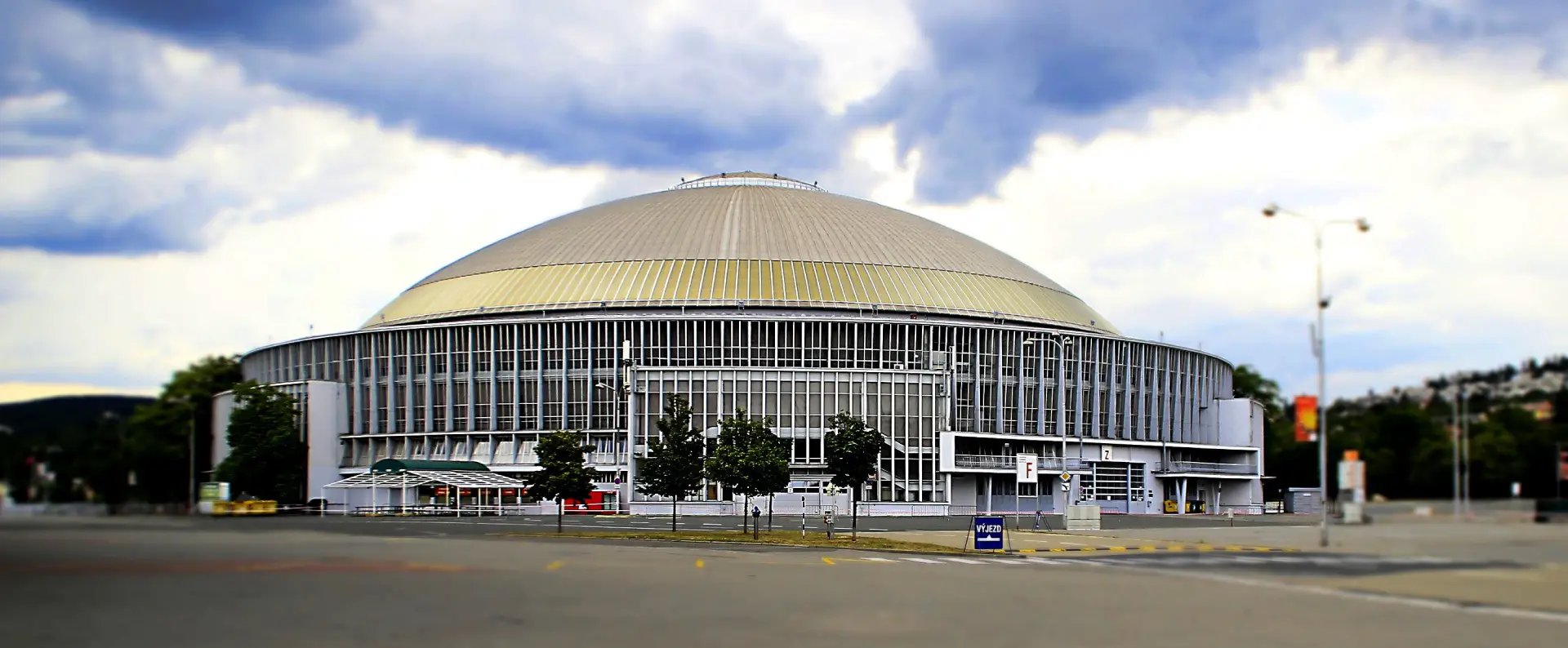 Exterior view of large modern exhibition hall with distinctive dome architecture