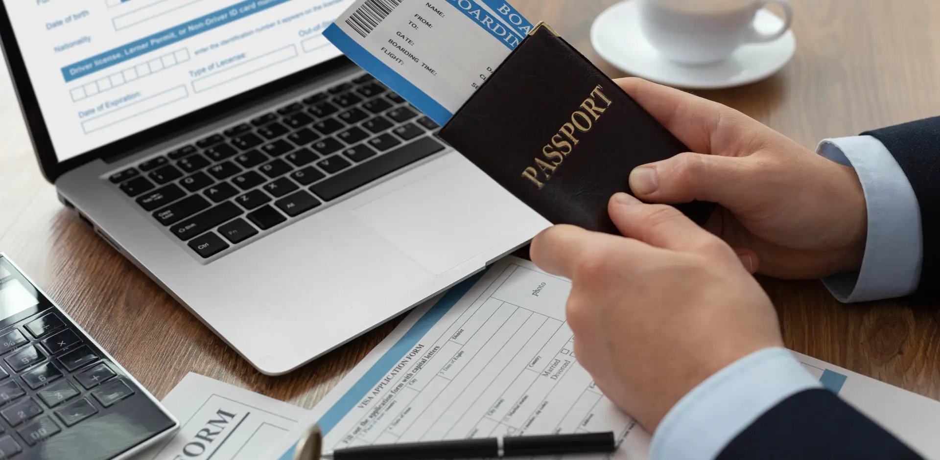 Business professional reviewing passport and visa documents with laptop