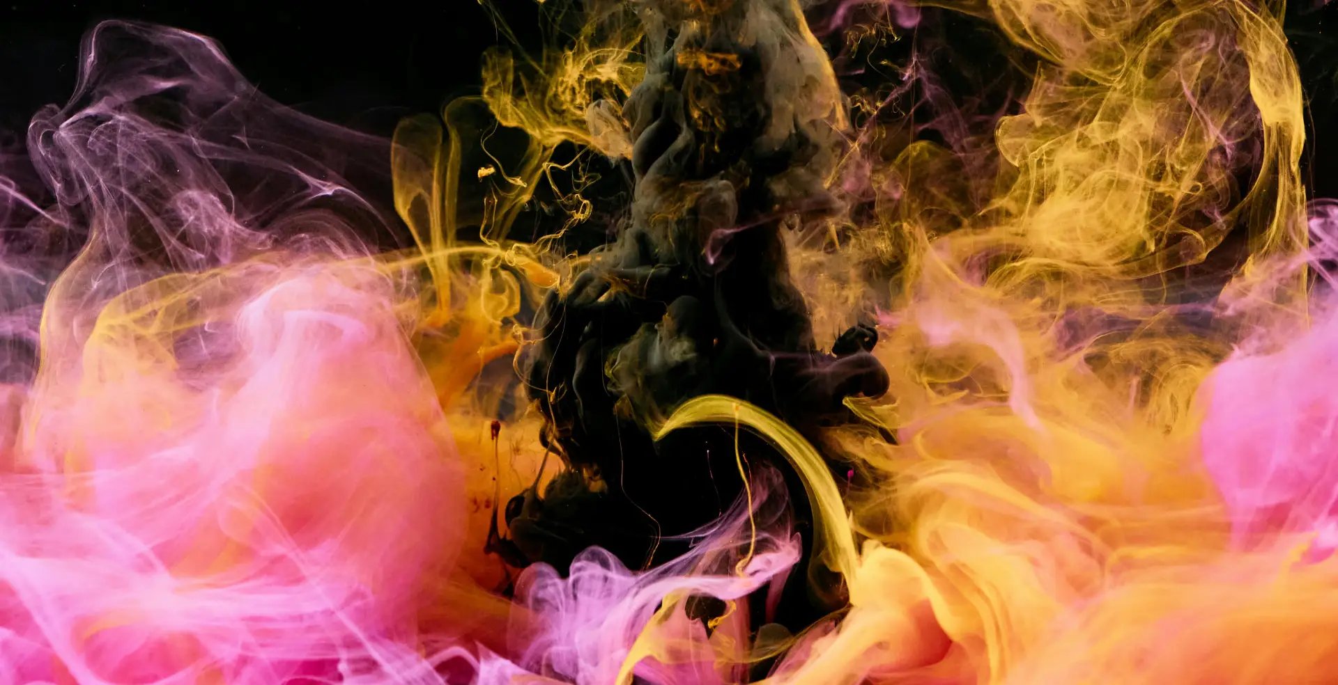 Colorful smoke clouds in vibrant pink, yellow and black artistic composition