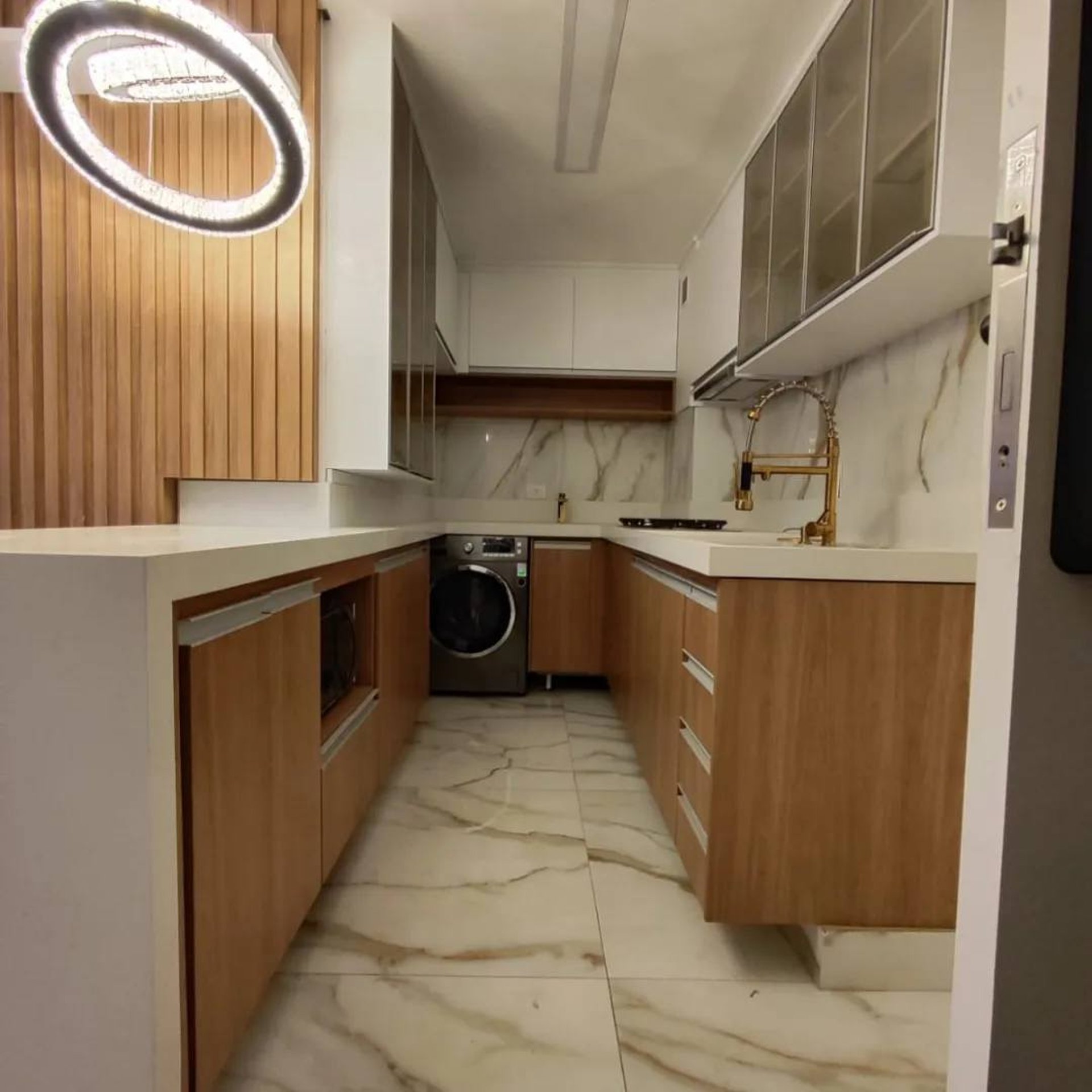 A modern, well-lit kitchen with a white color scheme.