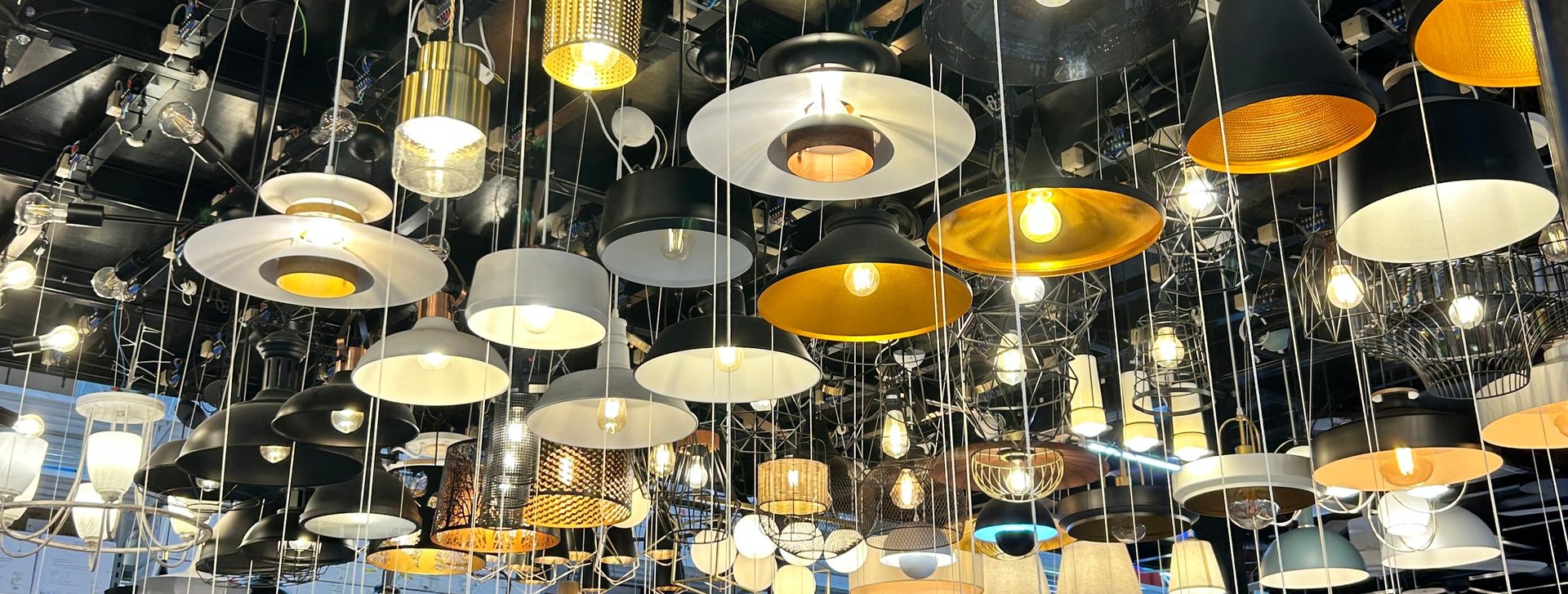 A green lamp hanging from a wooden ceiling